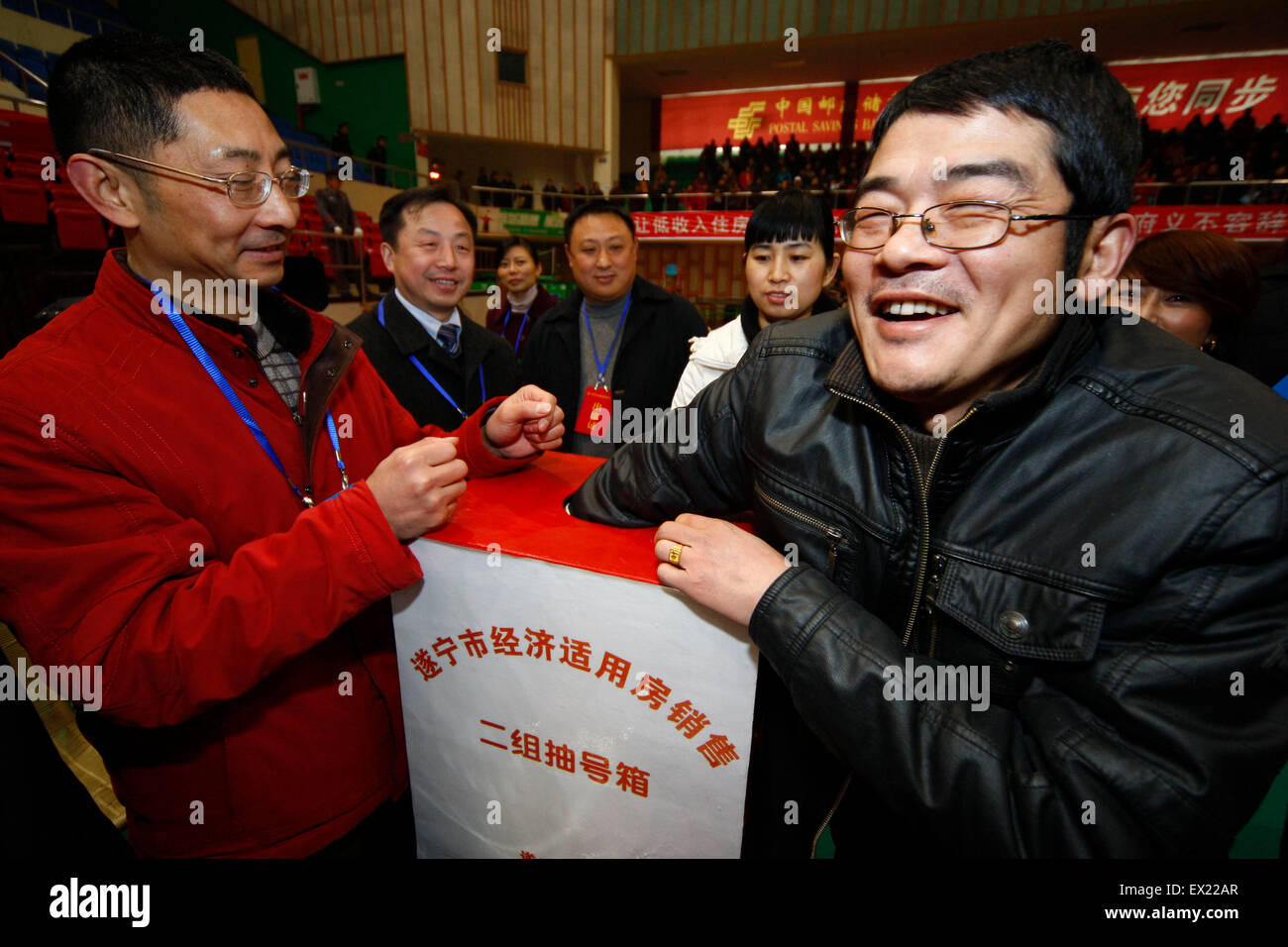 A citizen gets his number from a  lucky-tub to chose affordable housing in Suining, Sichuan province January 18, 2009. VCP Stock Photo