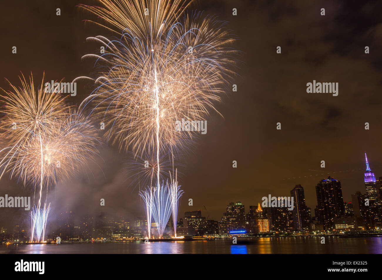 New York, USA. 4th July, 2015. Fireworks are seen over the East River ...