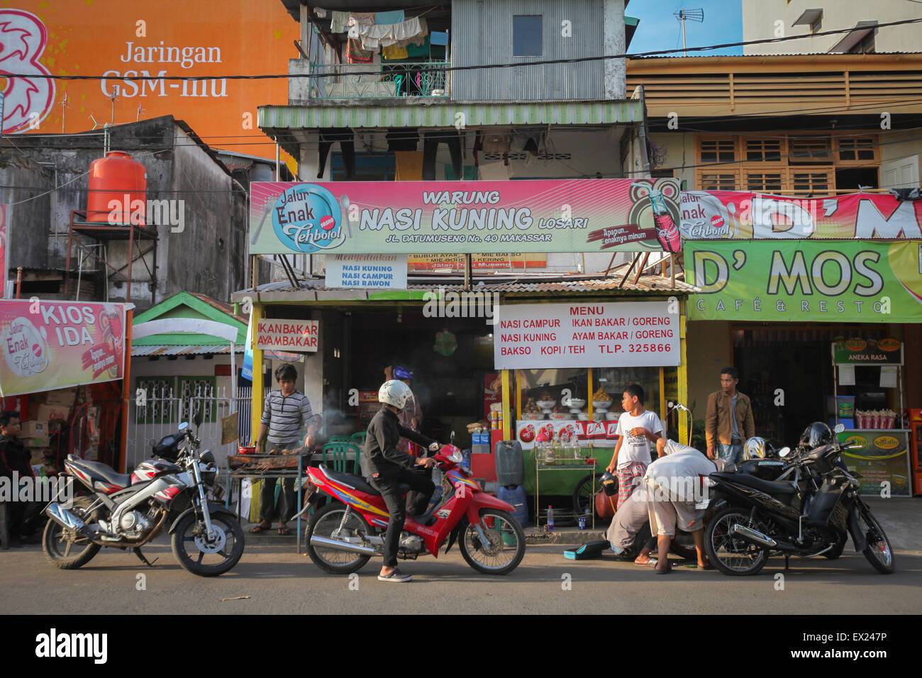 A scene on the side of Datu Musseng (Museng) Street, a locality with culinary vendors—some are traditionals—in Makassar, South Sulawesi, Indonesia. Stock Photo
