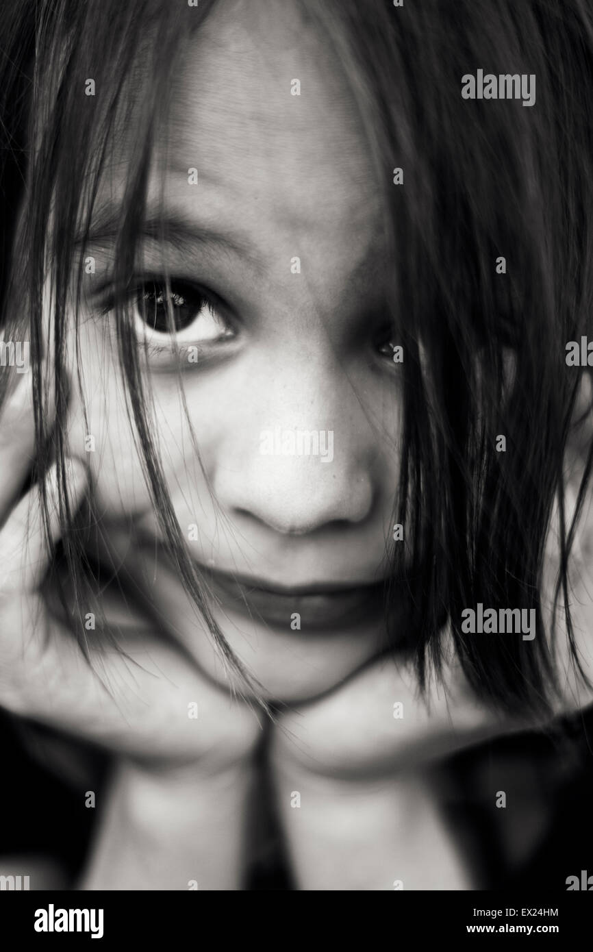 Young child making faces in close-up Stock Photo