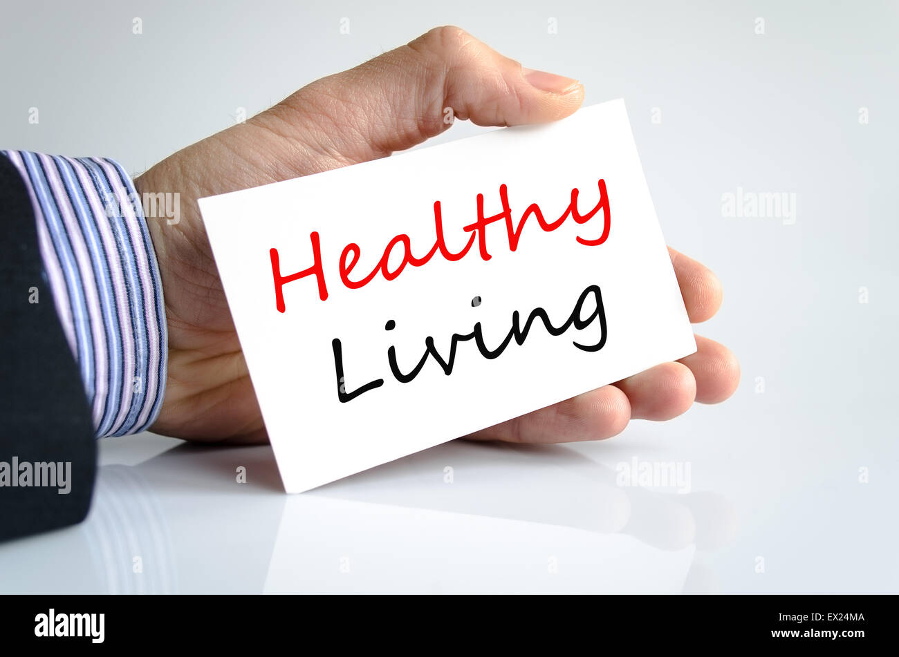 Healthy living text note in business man hand Stock Photo