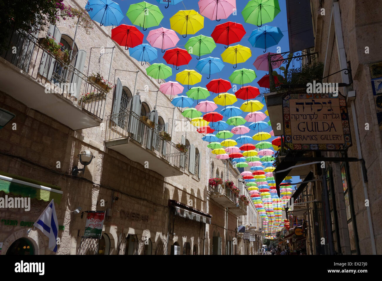 Colorful umbrellas are suspended above Yoel Solomon street in Nahalat