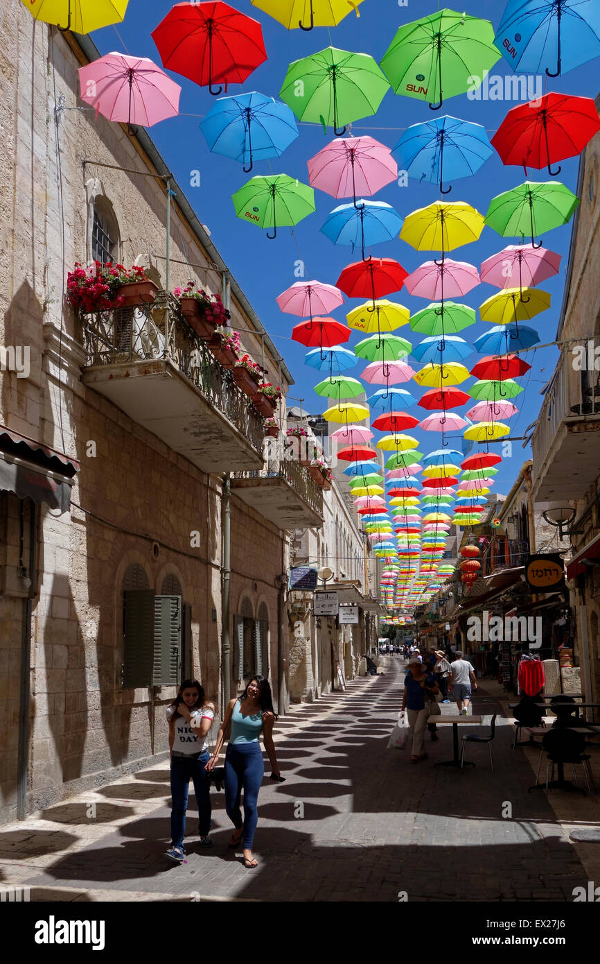 Colorful umbrellas are suspended above Nahalat Shiva which was the third  neighborhood built outside the Old City of Jerusalem in the 1860s. Today it  is a crowded pedestrian promenade lined with sidewalk