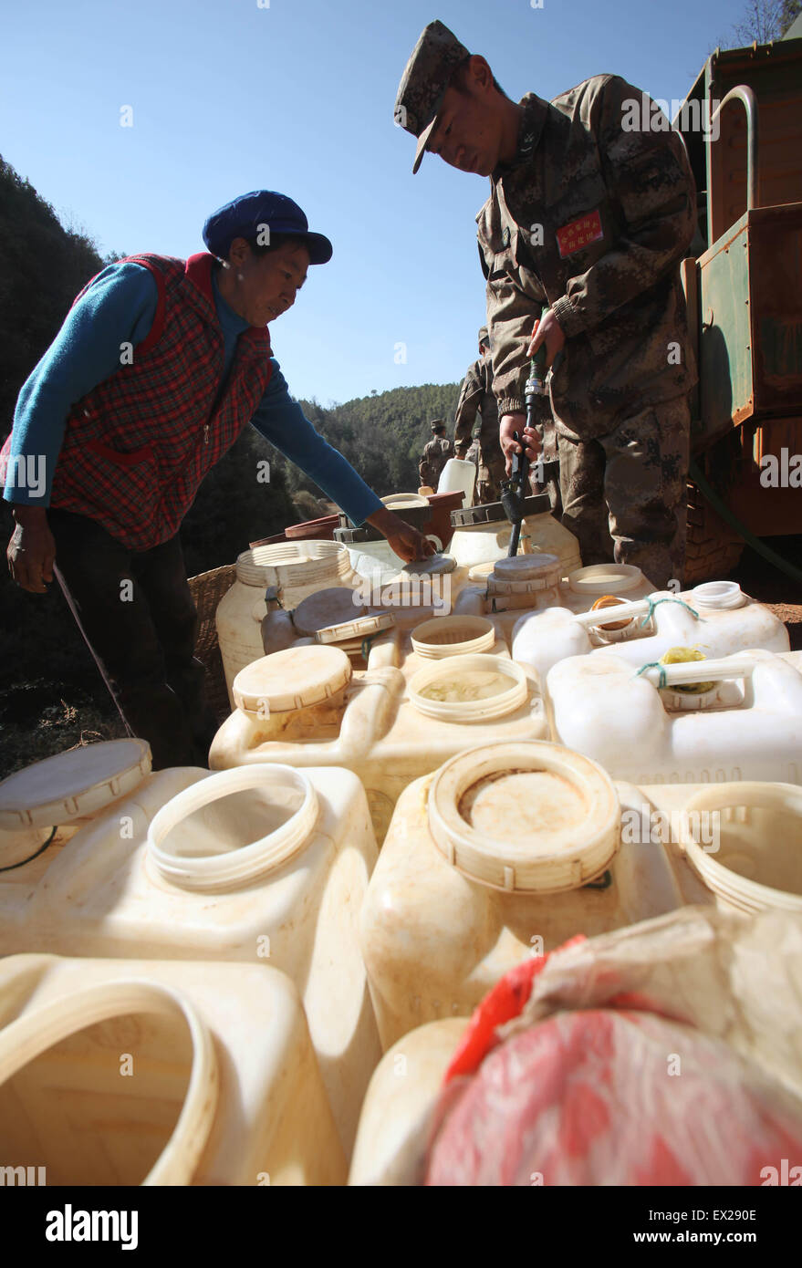 Locals wait to get water delivered by the soldiers of People's Liberation Army at a drought-hit village in Luquan, Yunnan provin Stock Photo