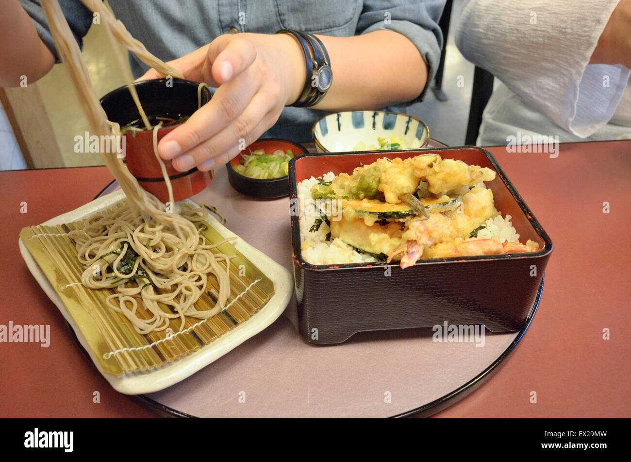 Eating soba and tempura at a Japanese restaurant. Stock Photo