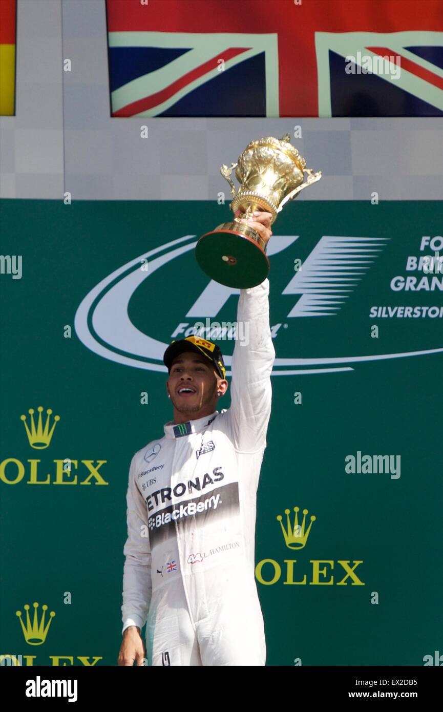 Silverstone, Northants, UK. 05th July, 2015. Formula 1 British Grand Prix. Lewis Hamilton, Mercedes AMG Petronas F1 Team holds the winners trophy on the podium after his 3rd British GP win. Credit:  Action Plus Sports/Alamy Live News Stock Photo