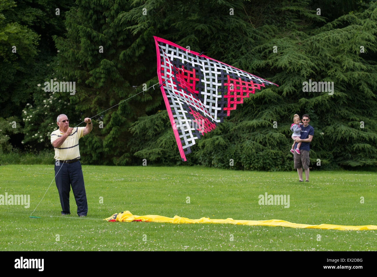 Young boy looks up as he hold a single-string wooden kite reel Stock Photo  - Alamy