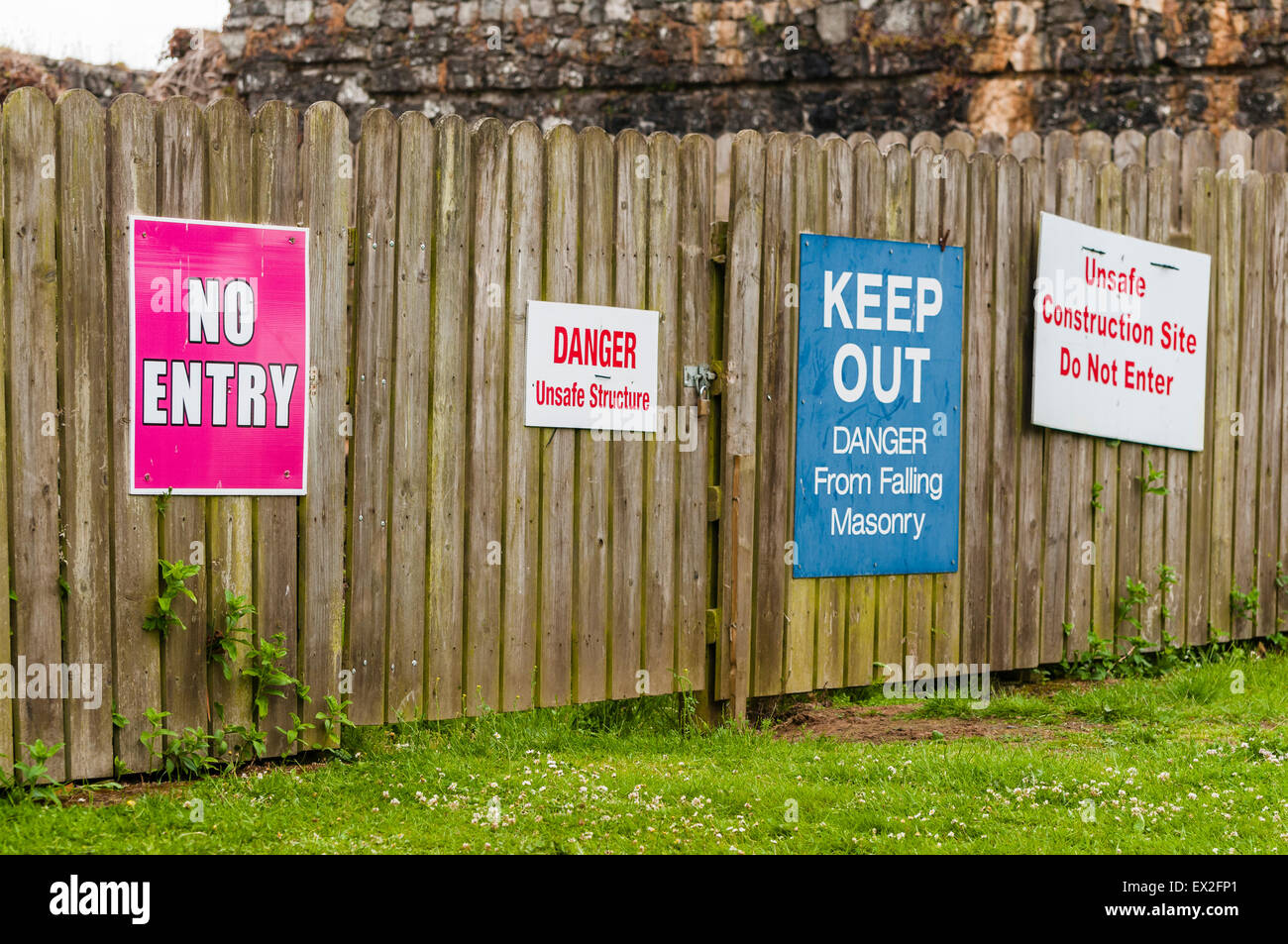 Signs advise people to keep away from an unsafe building Stock Photo