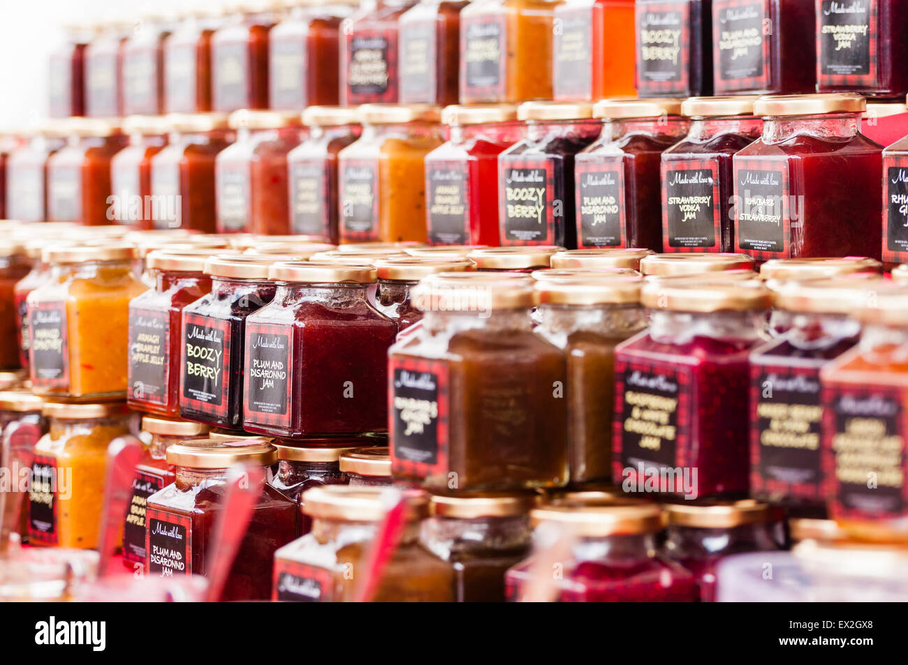 Jars of jams and chutneys on sale at a market stall Stock Photo