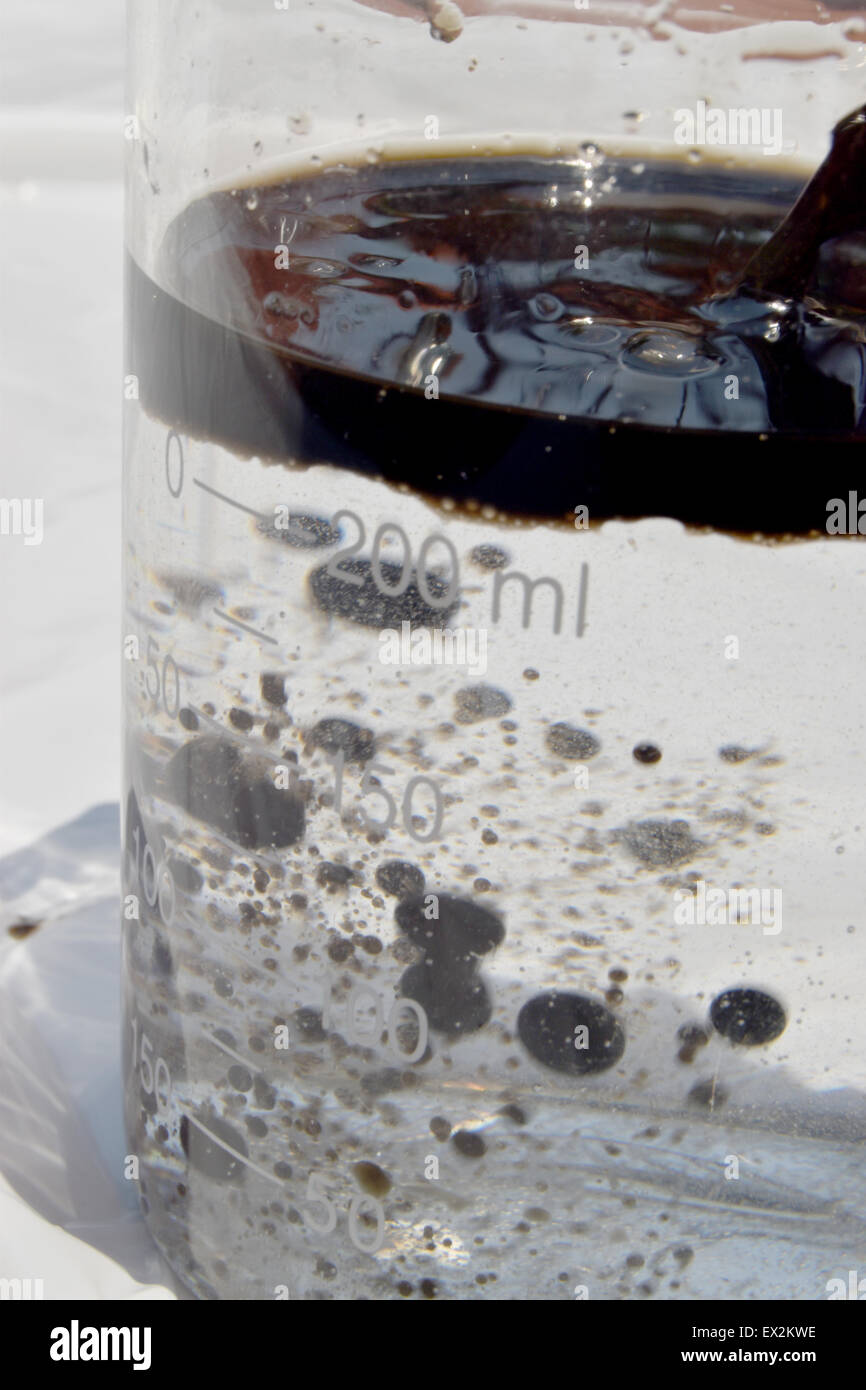 motor oil with water in beaker Stock Photo