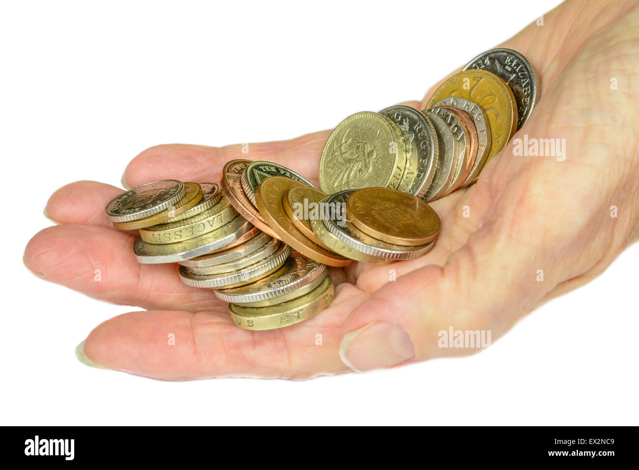 Woman's hand holding UK decimal sterling coins on a white background. Stock Photo