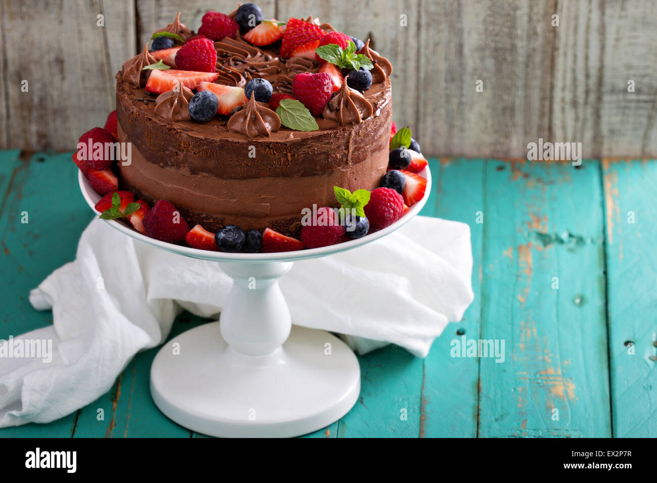 Chocolate cheesecake and devil food layer cake with fresh berries Stock Photo