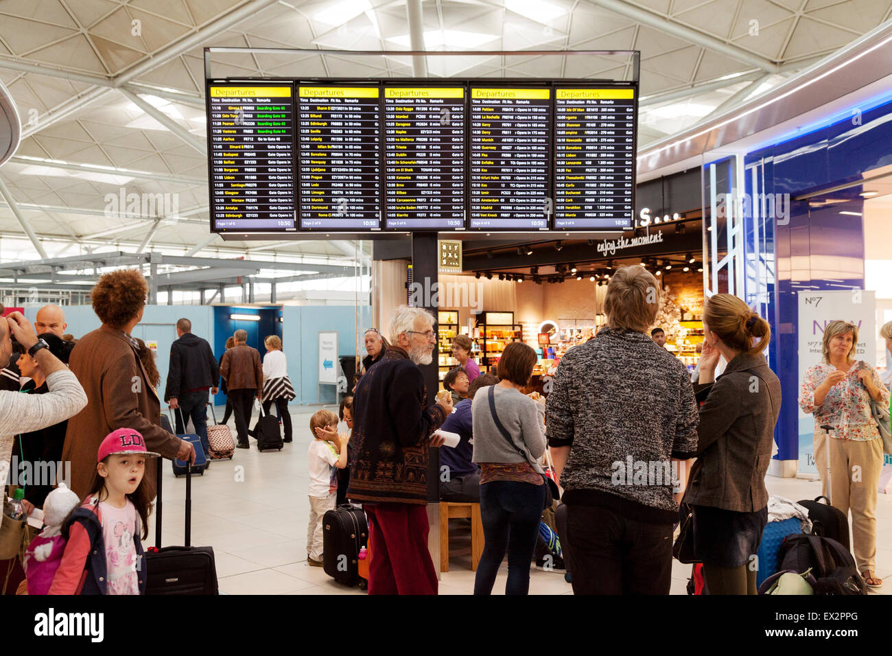 People looking at the departure board, departure lounge, Stansted airport, Essex UK Stock Photo