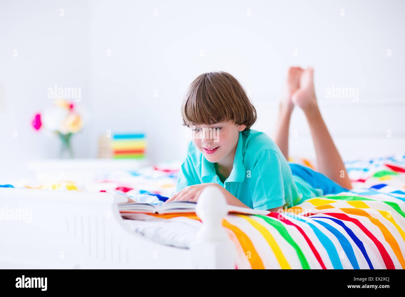 School age boy reading a book in bed. Children read books. Kids learning.  Student kid doing homework in a sunny bedroom Stock Photo - Alamy