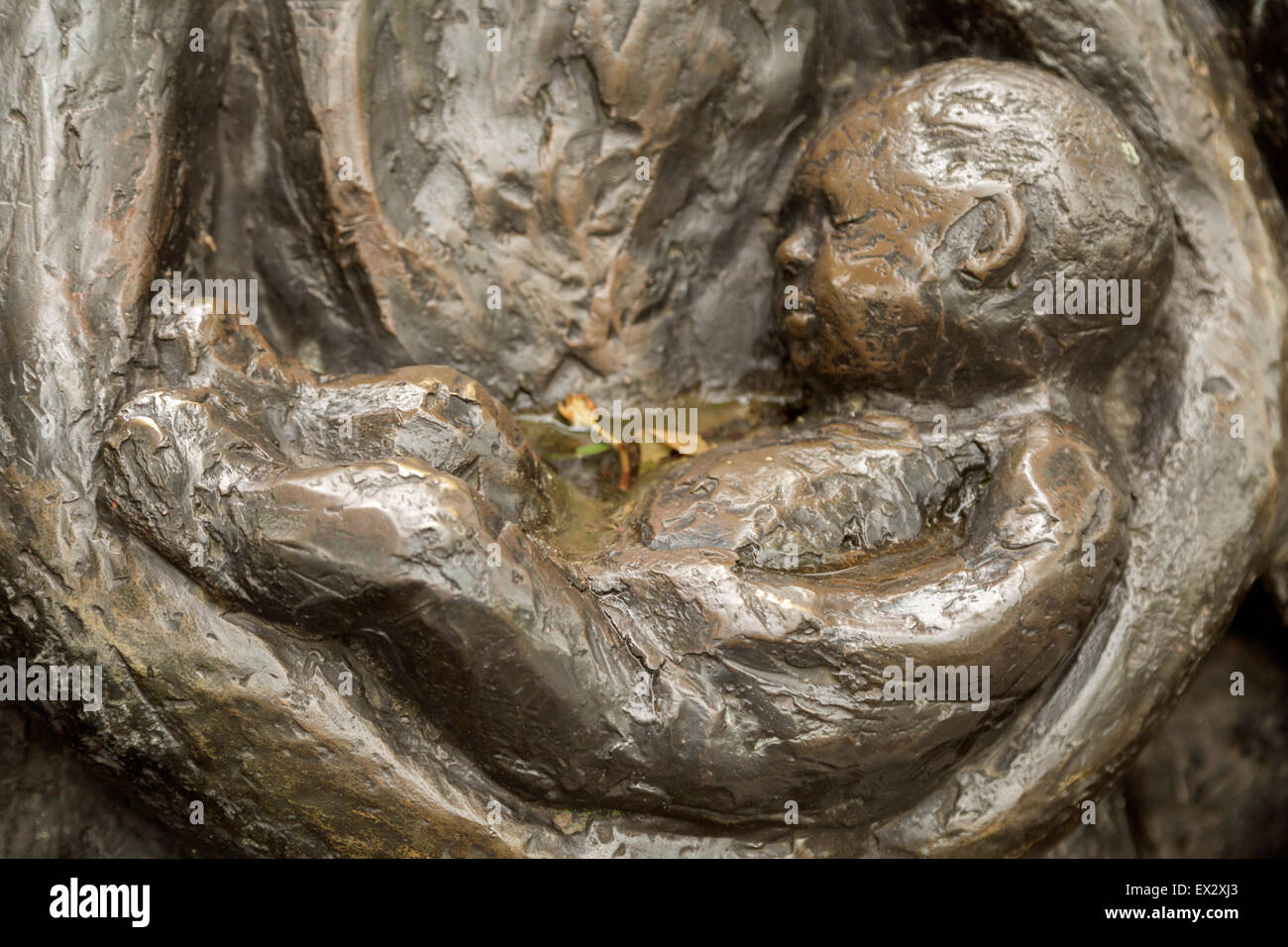 Detail of a sculpture, showing a baby asleep in his mother's arms, in Oudewater, province of Utrecht, The Netherlands. Stock Photo