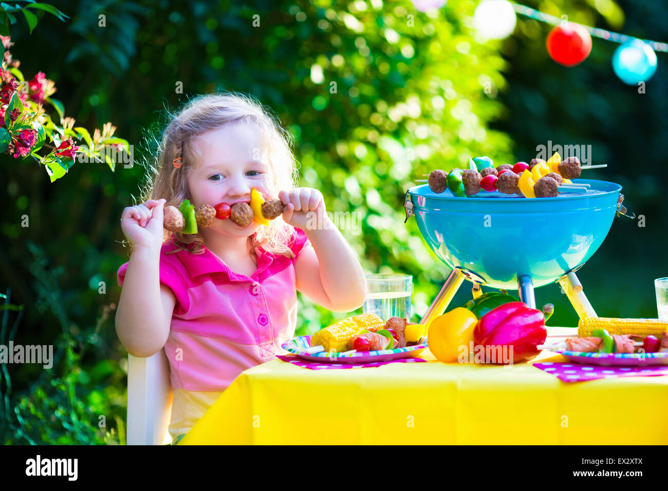 Children grilling meat. Family camping and enjoying BBQ. Little girl at