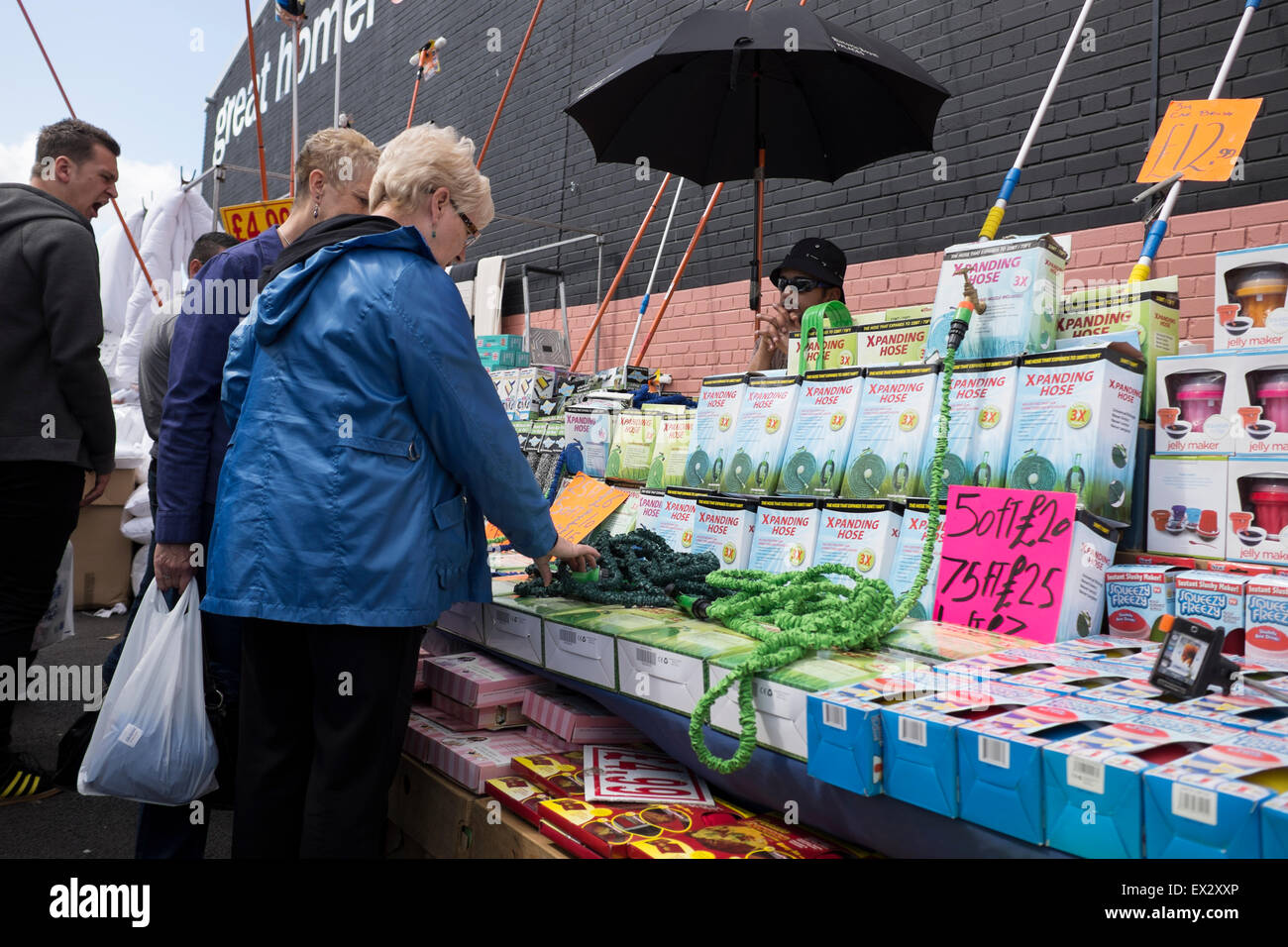Outdoor market selling garden hoses homeware Stock Photo