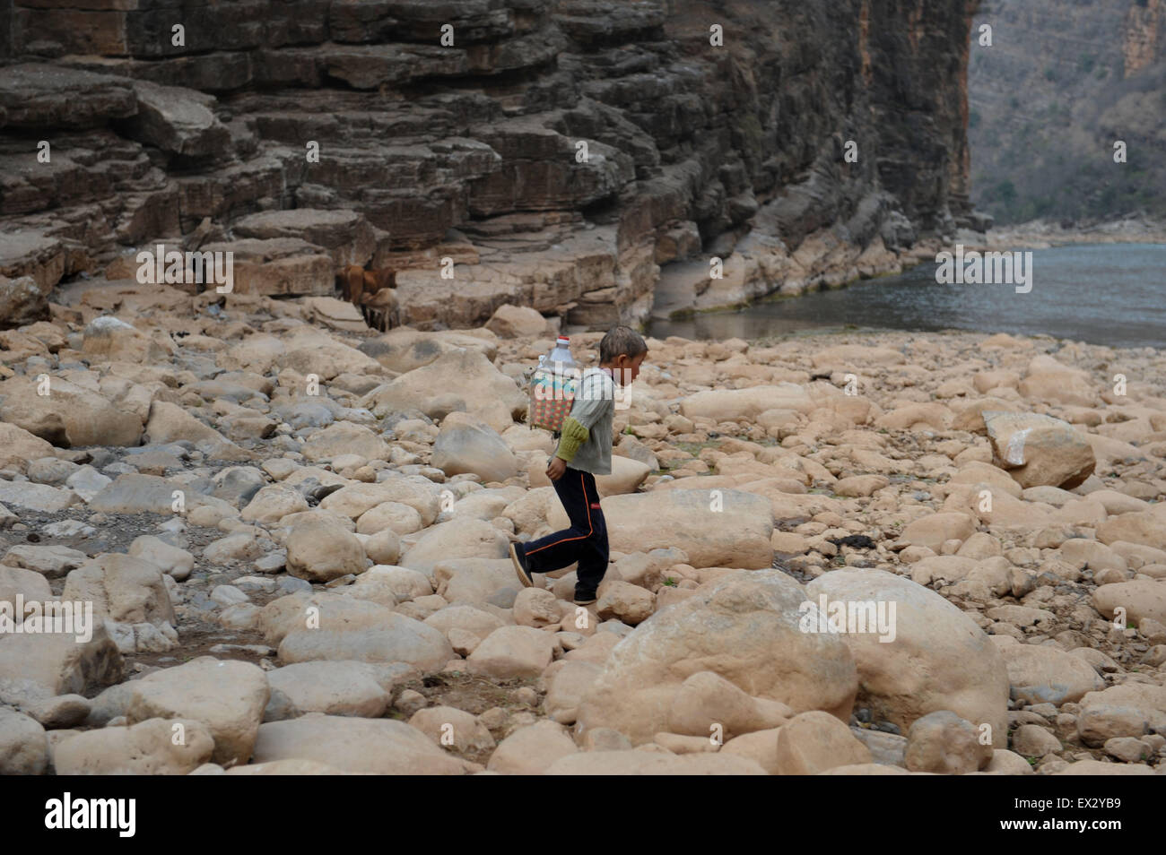 A boy carries drinking water on outskirts of Qujing, Yunnan province, March 26,2010.A severe drought across a large swathe of so Stock Photo