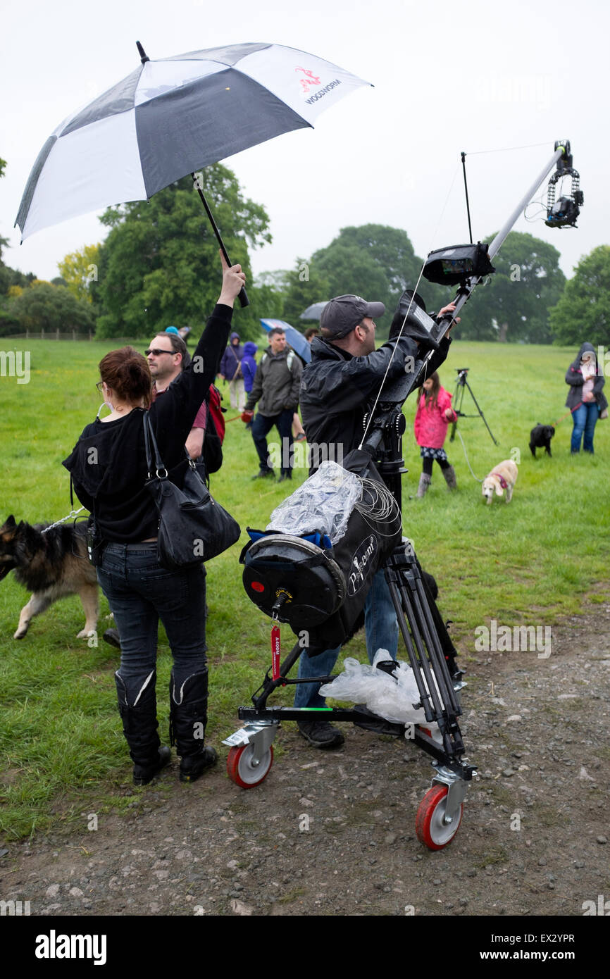 Outside Broadcast Television Crew Filming in Rain Stock Photo