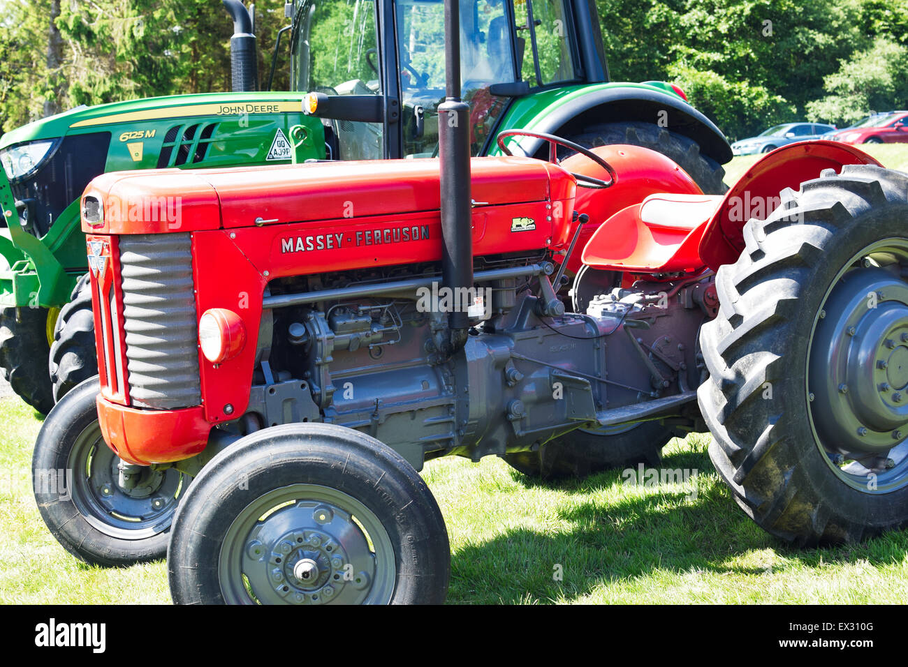 Red Massey Ferguson tractor, with green John Deere tractor behind Stock  Photo - Alamy