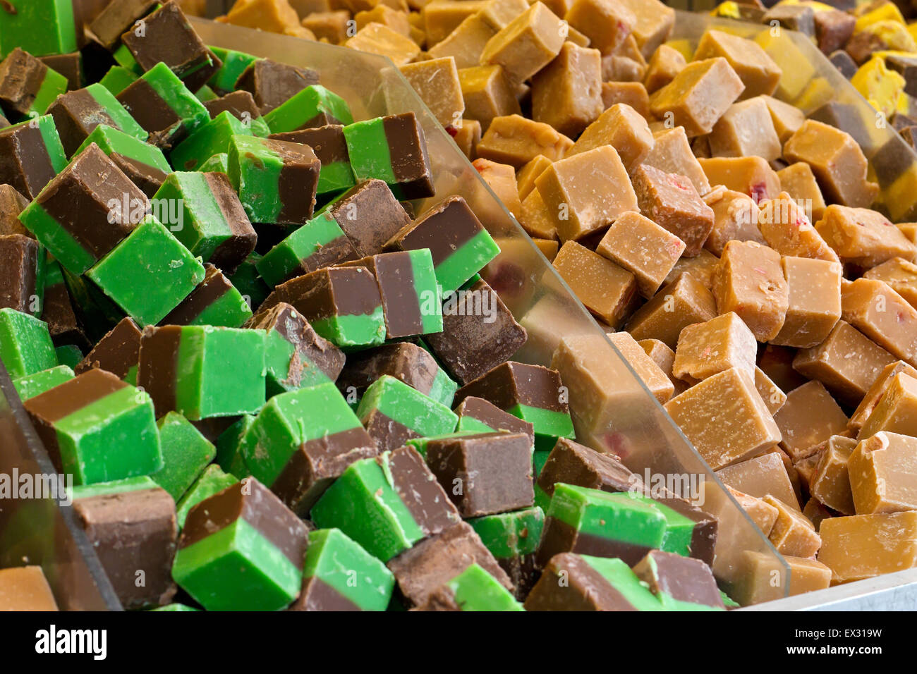 Selection of fudges for sale in a grocery stores pick n mix counter, where people buy there favourite sweets chosen from a varie Stock Photo