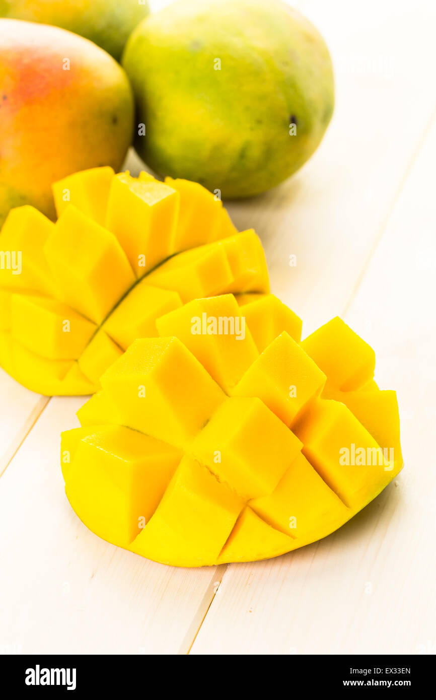 Fresh organic mango on a white wood board. Stock Photo