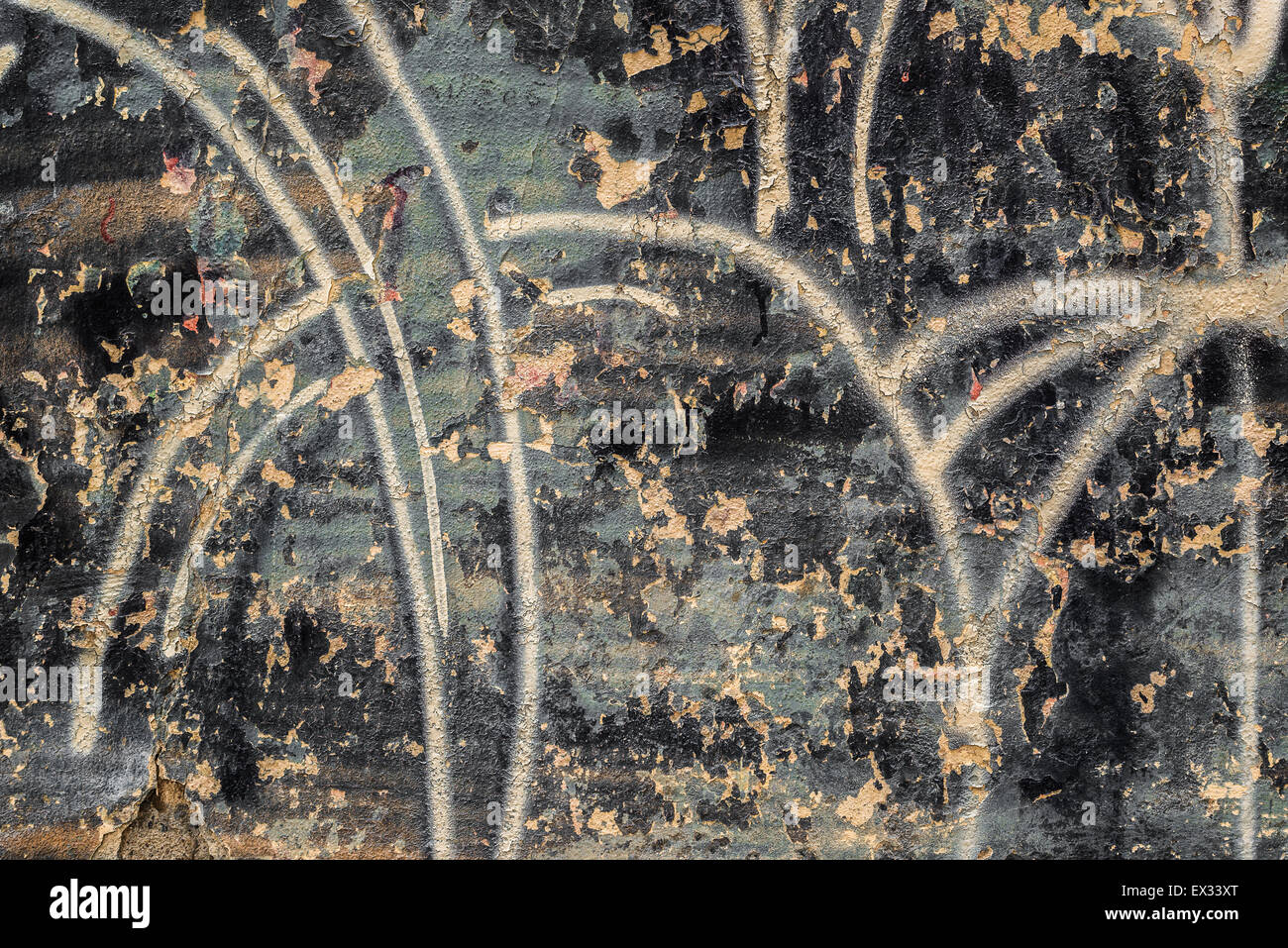 Grunge Wall with Black Paint Peel and Graffiti Spray as Urban Decay Backdrop Stock Photo