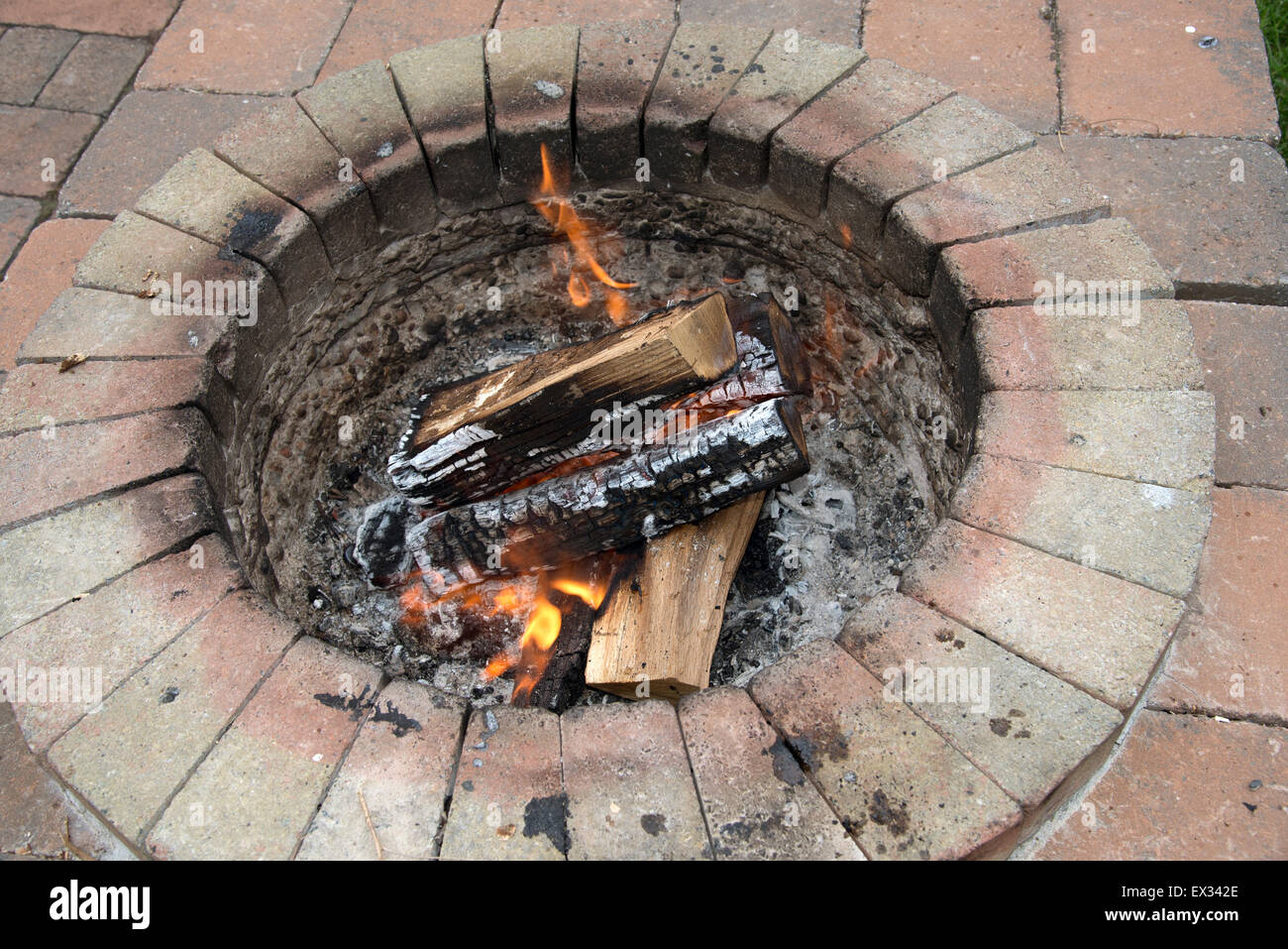 Burning Wood In A Garden Fire Pit Almost Ready To Cook On Stock