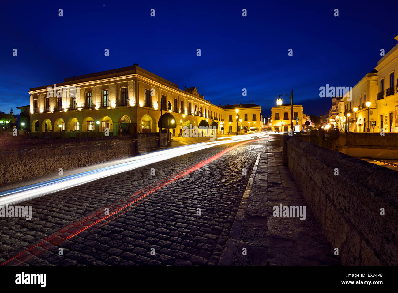 Car head and tail light trails at twilight on the Puente Nuevo bridge