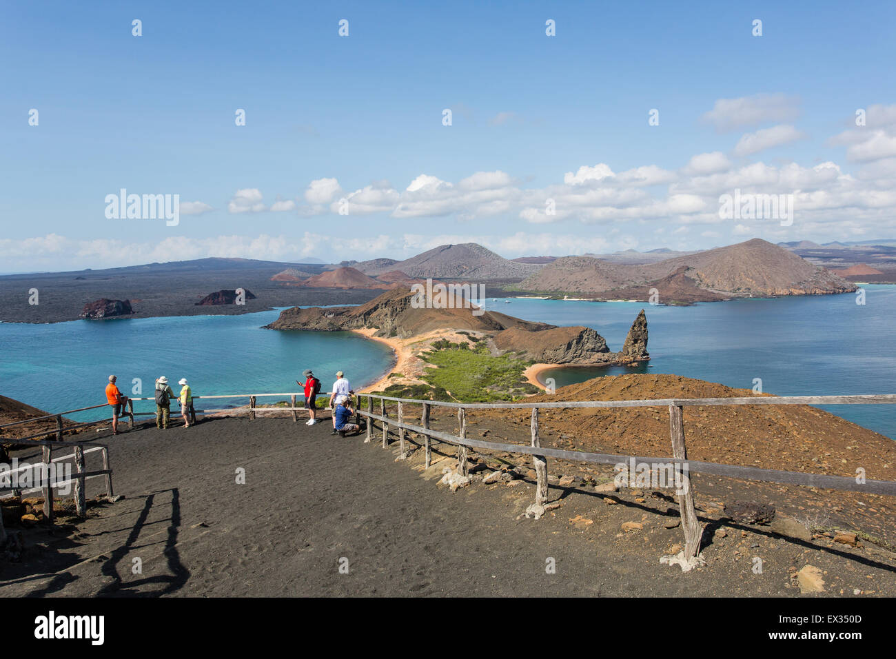 Visitors admire an iconic view over Pinnacle Rock in the Galapagos Islands. Stock Photo