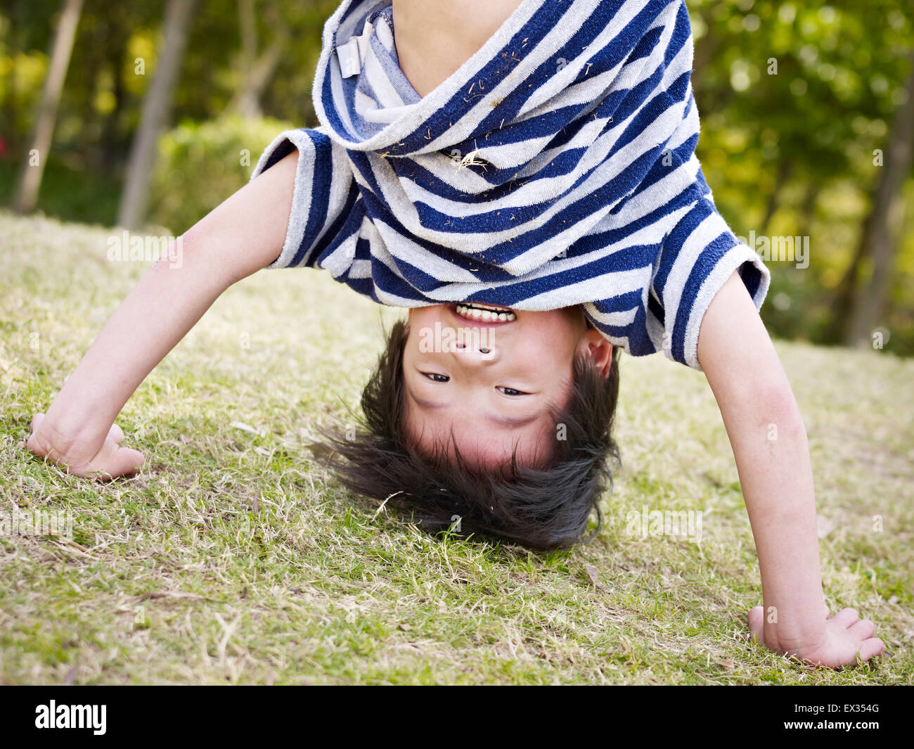 little asian boy playing playing outdoors Stock Photo