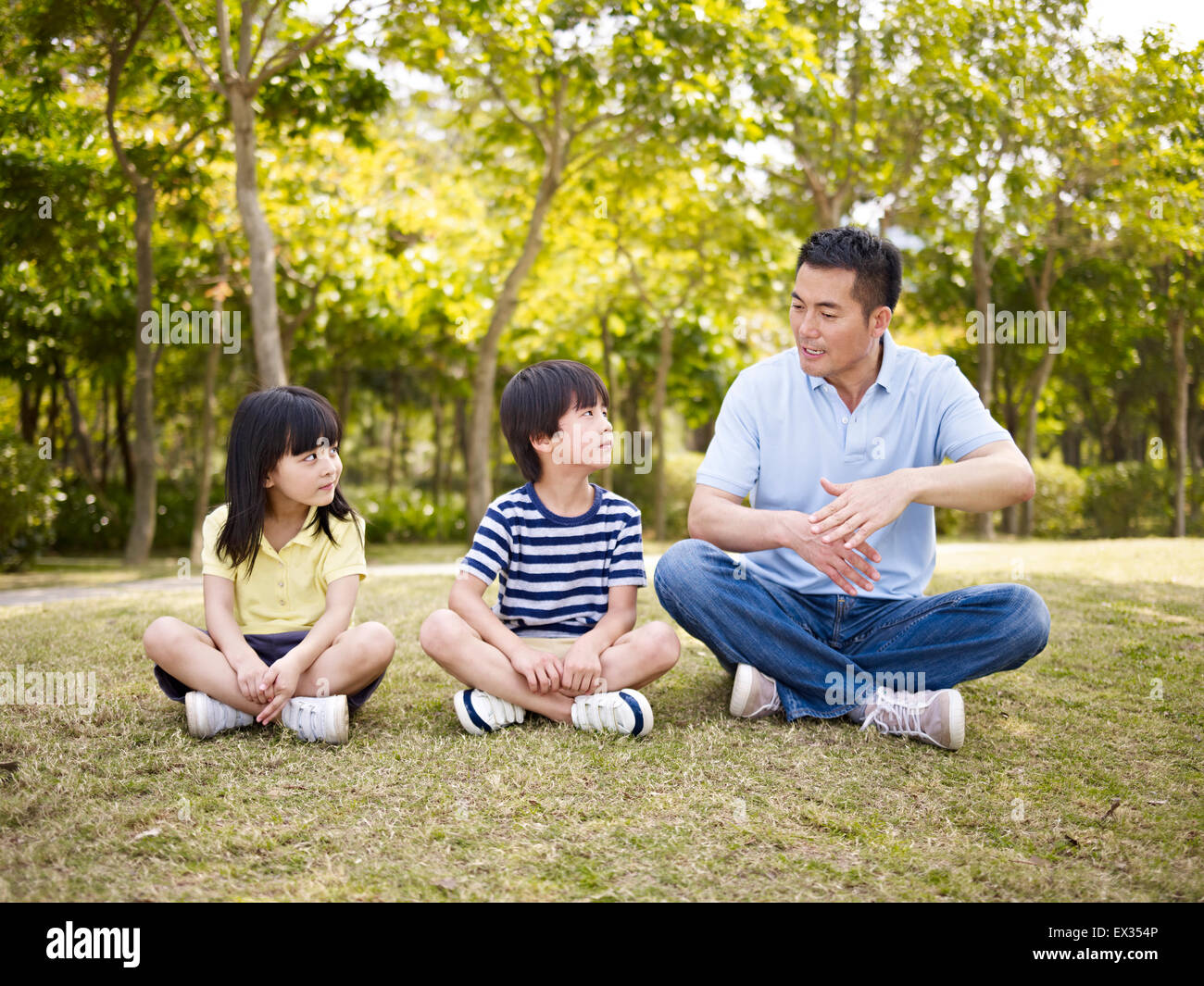 asian father and children having fun outdoors Stock Photo