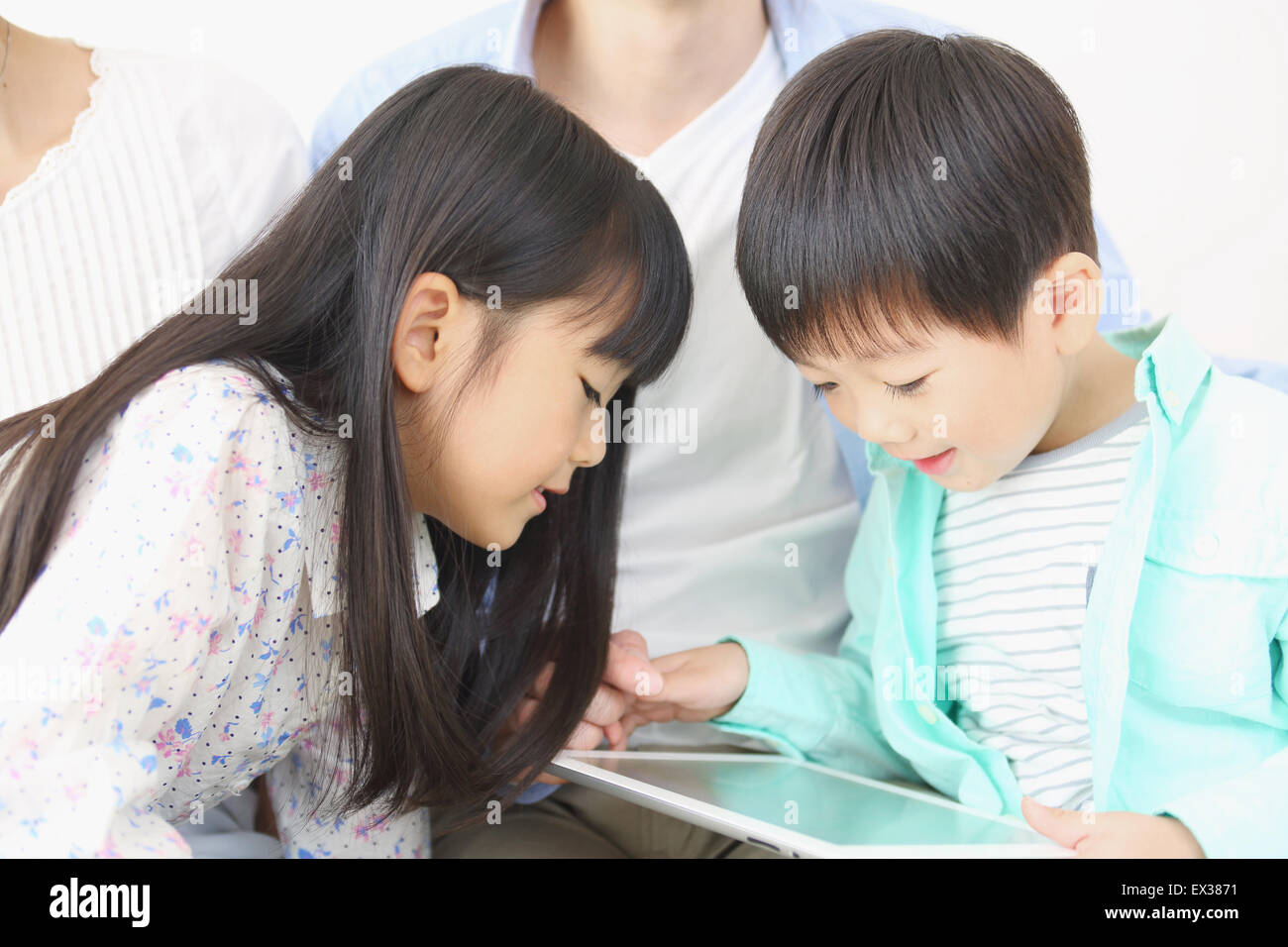 Japanese family playing with tablet Stock Photo