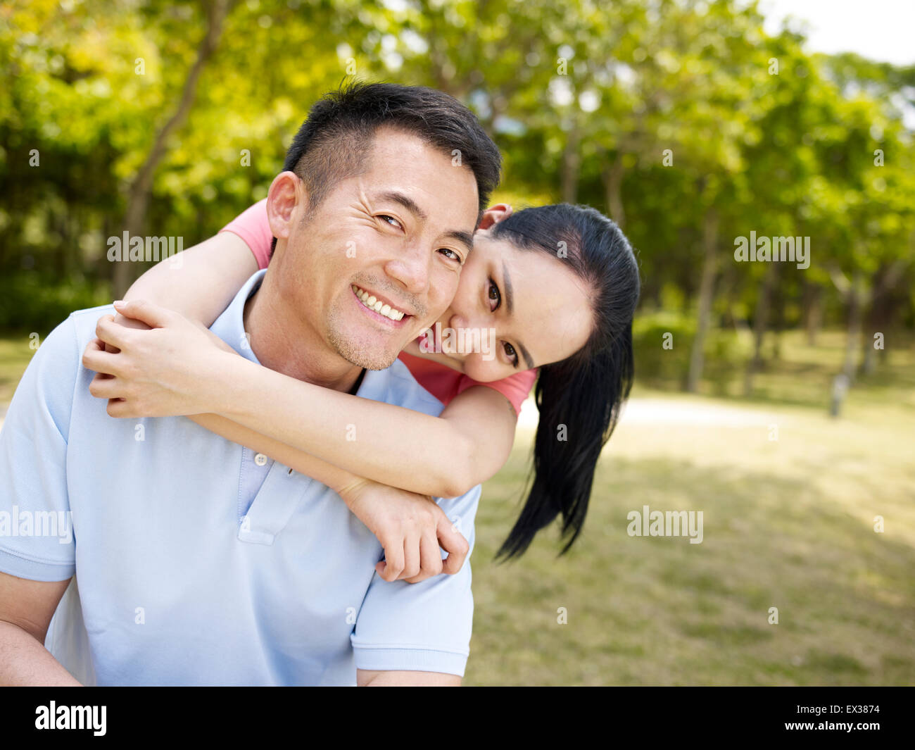 loving asian couple in park Stock Photo