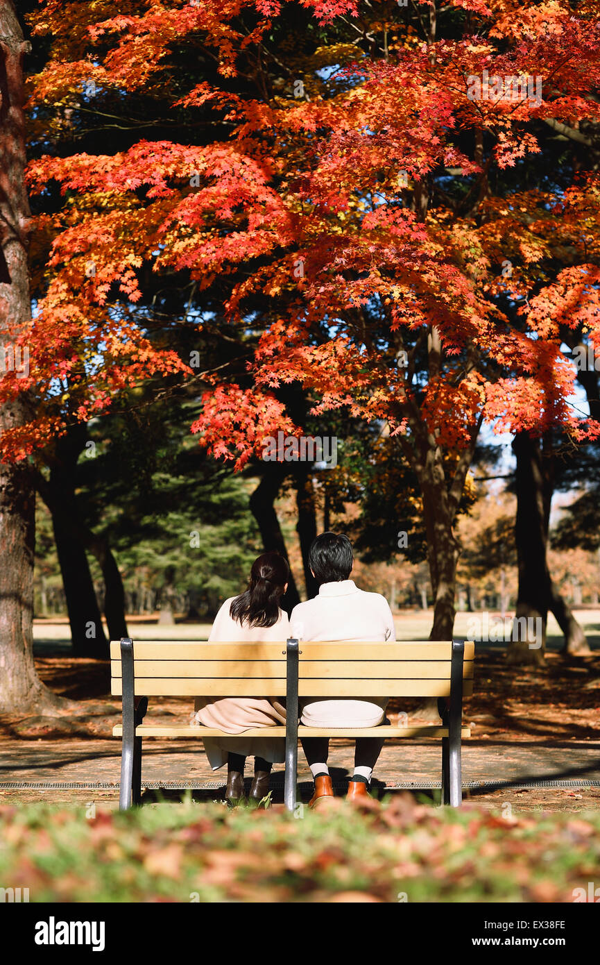 Senior Japanese couple sitting on a bench in a city park Stock Photo ...
