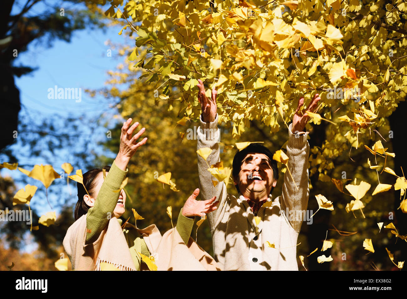 Senior Japanese couple in a city park in Autumn Stock Photo - Alamy