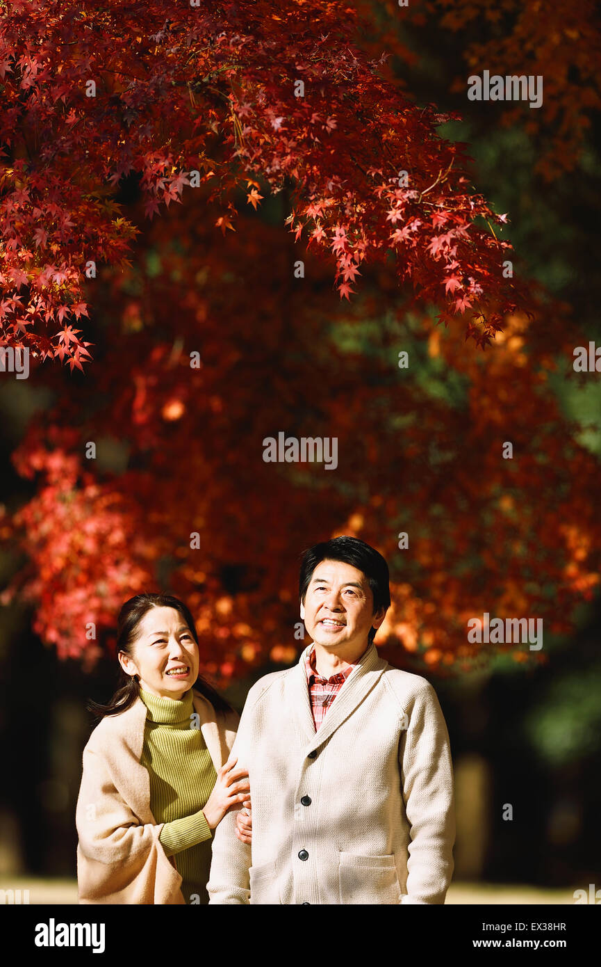 Senior Japanese couple in a city park in Autumn Stock Photo - Alamy
