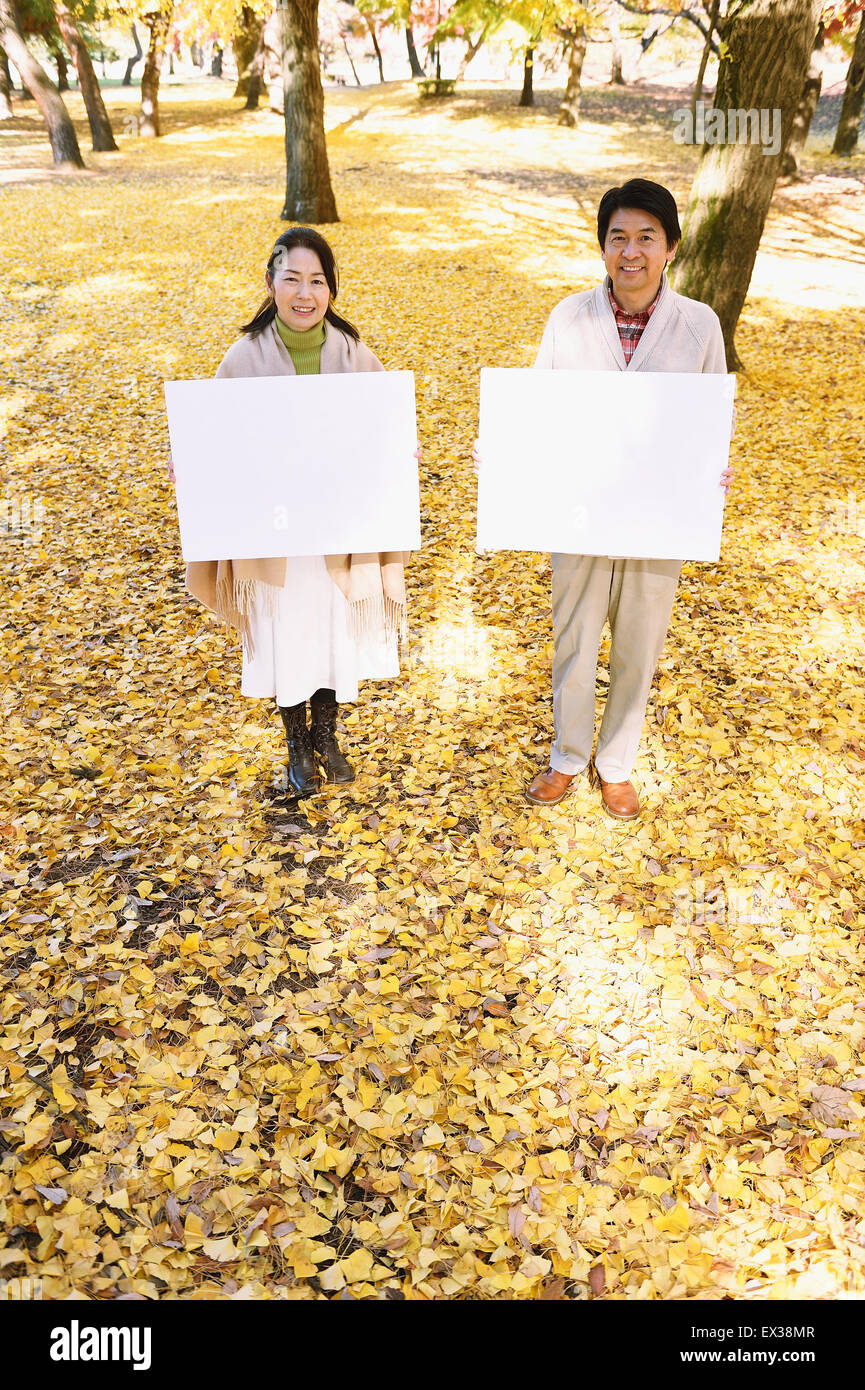 Senior Japanese couple with whiteboard in a city park Stock Photo - Alamy
