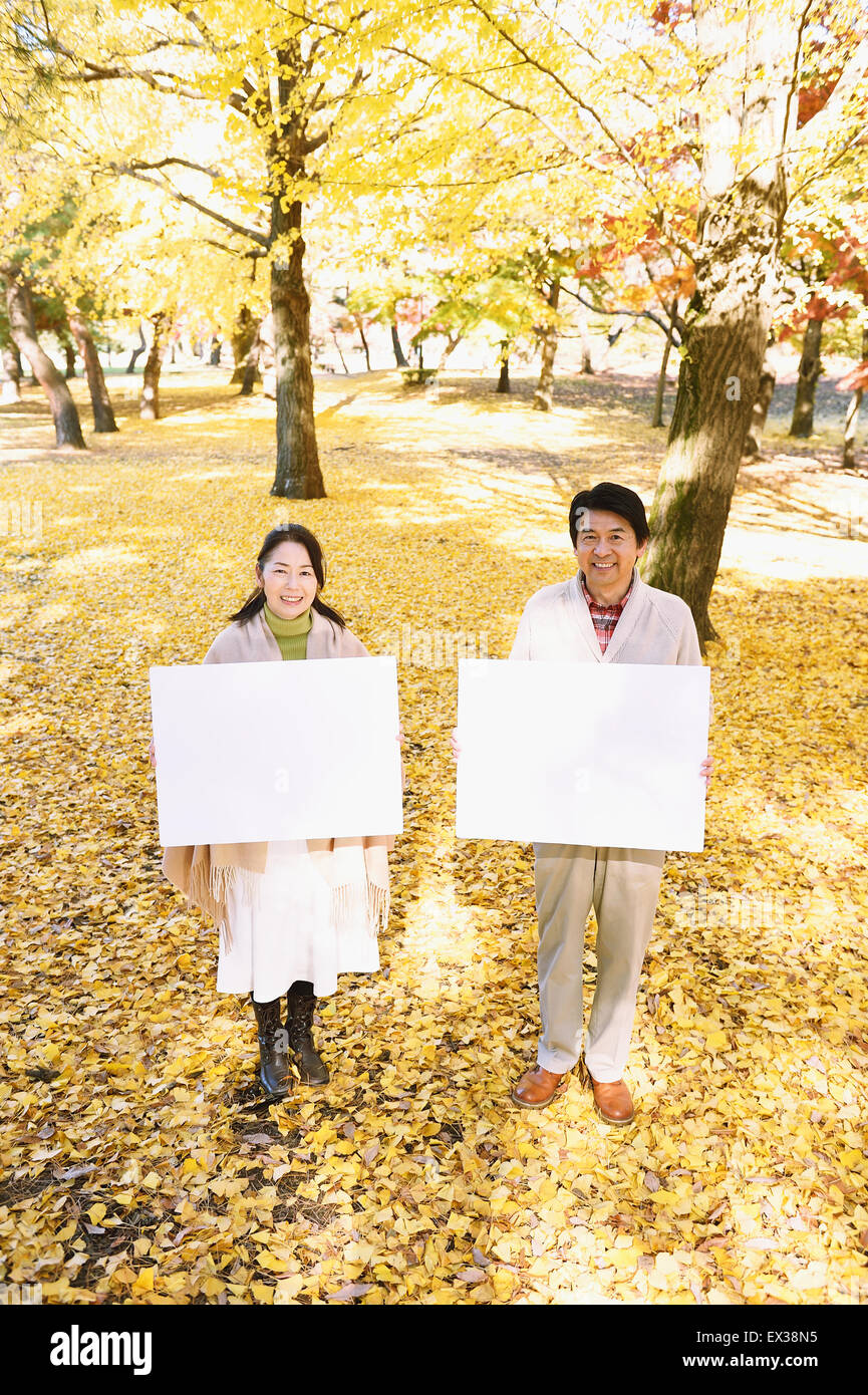 Senior Japanese couple with whiteboard in a city park Stock Photo - Alamy