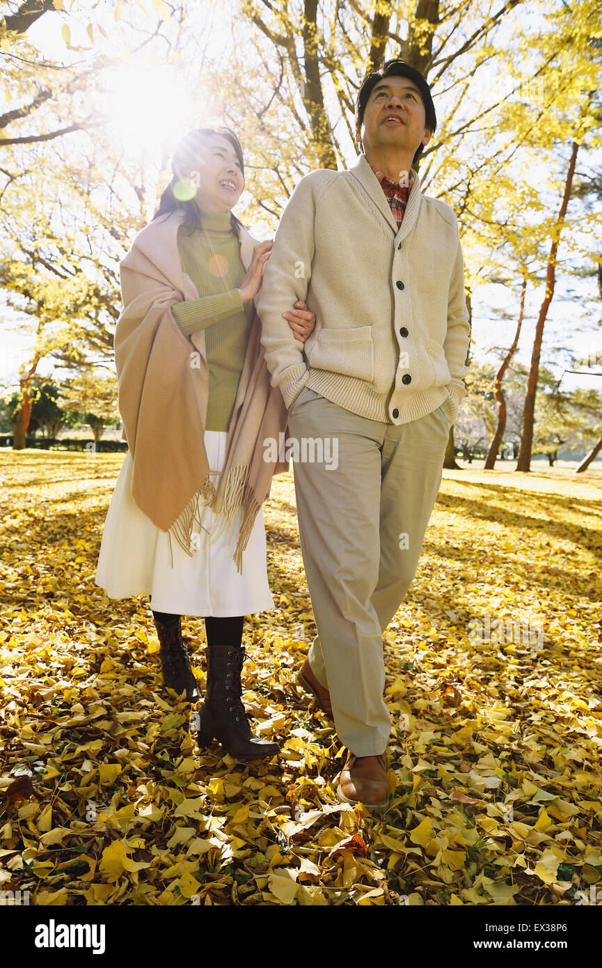 Senior Japanese couple in a city park in Autumn Stock Photo - Alamy