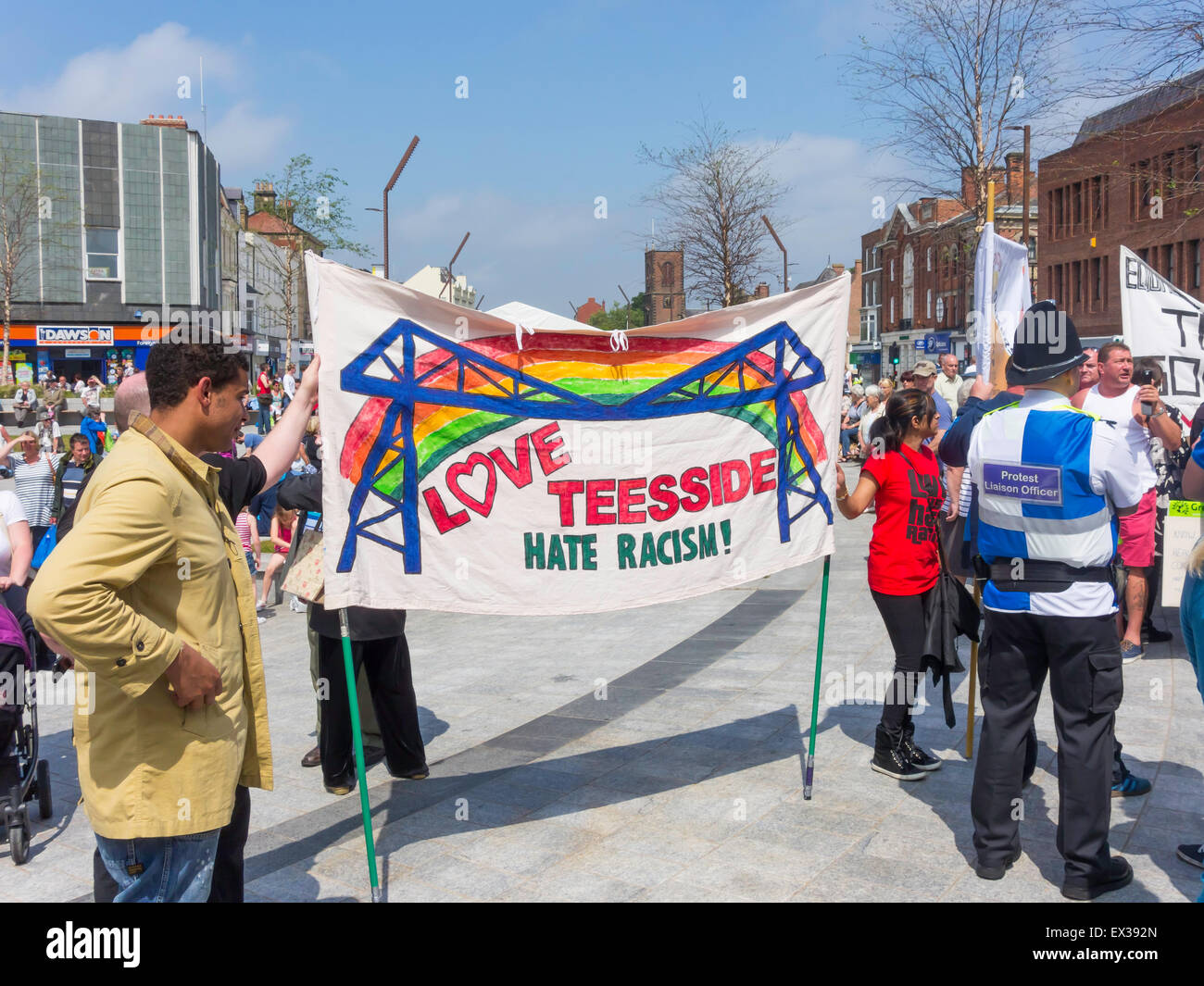 A counter-demonstration against a parade by an  Anti-Muslim Group with a  banner Love Teesside Hate Racism Stock Photo