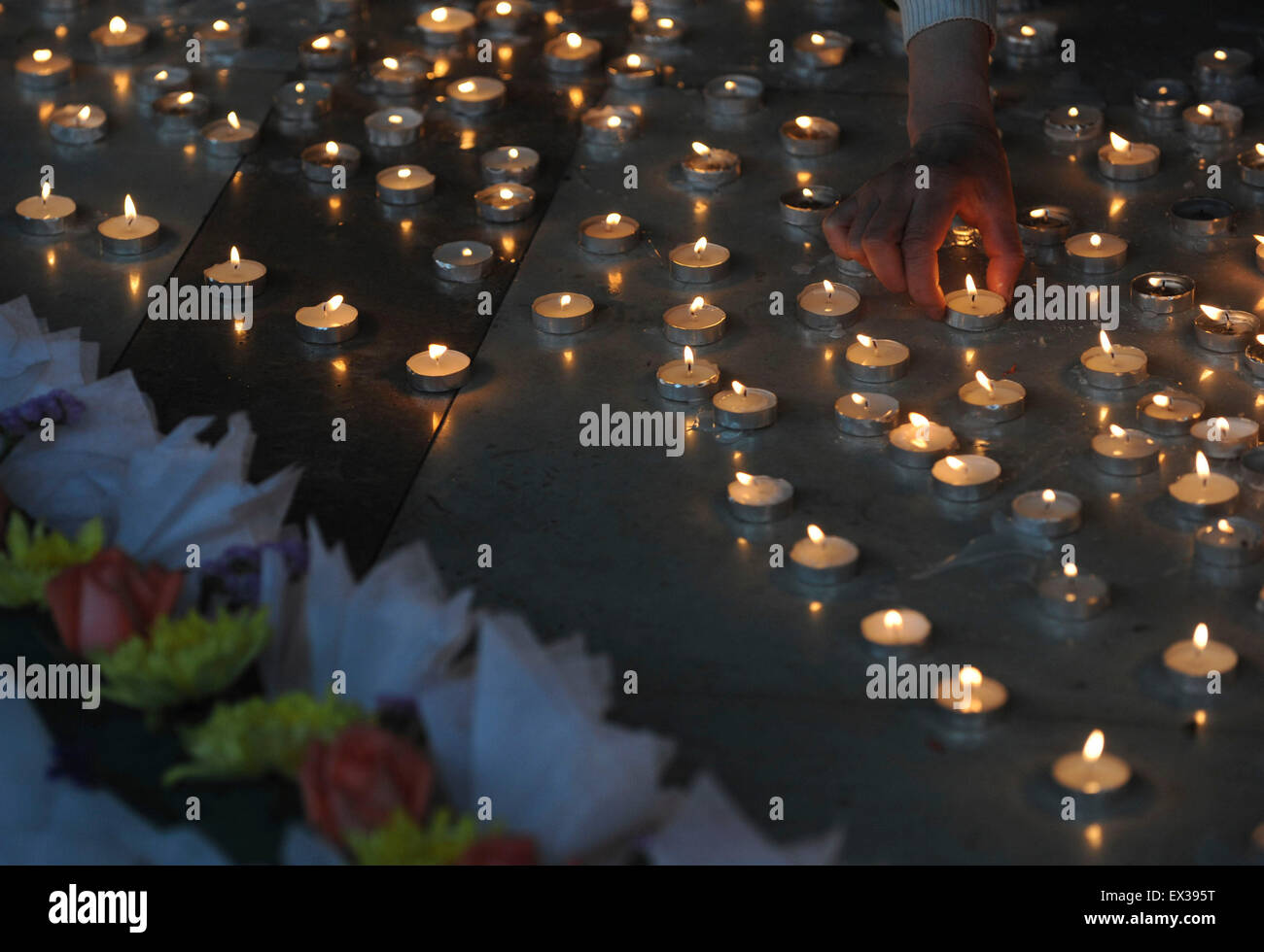 Poeple burn candles during an activity to mourn the victims who died during the Apri 14 Yushu earthquake of Qinghai province, at Stock Photo