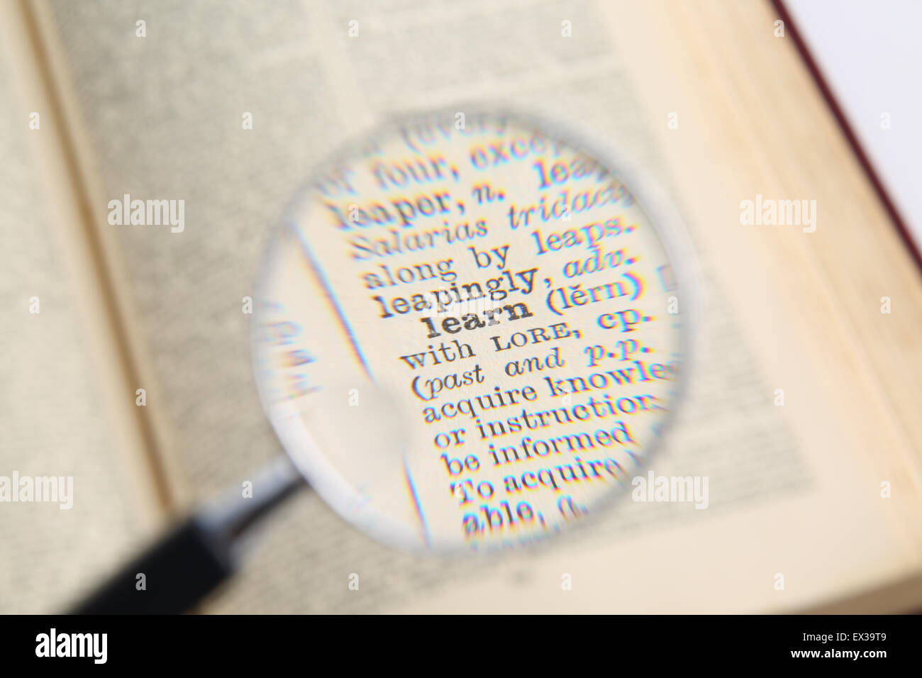 Dictionary and magnifying glass Stock Photo