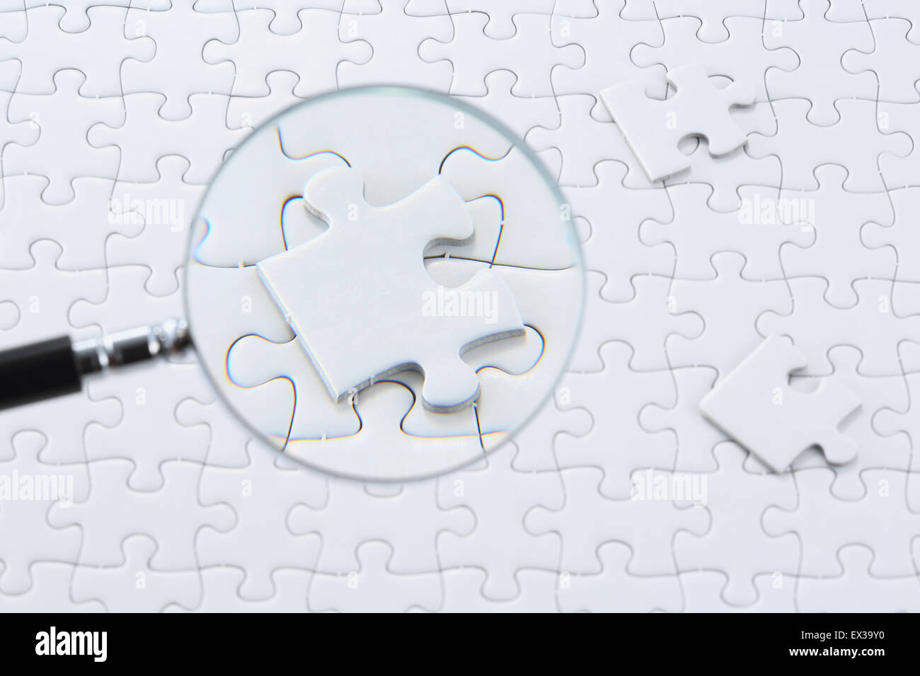 Jigsaw puzzle and magnifying glass Stock Photo Alamy