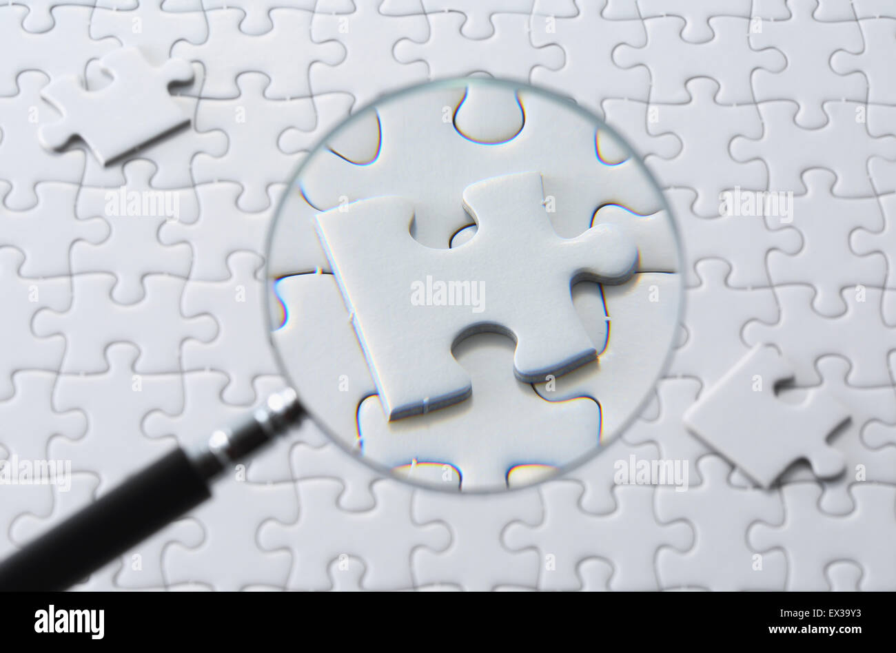 Jigsaw puzzle and magnifying glass Stock Photo Alamy