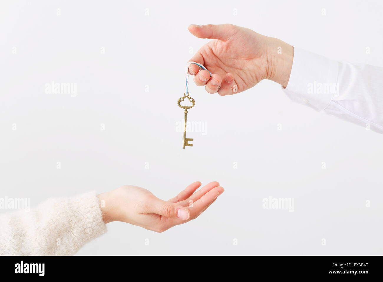 Man and woman hands passing key Stock Photo