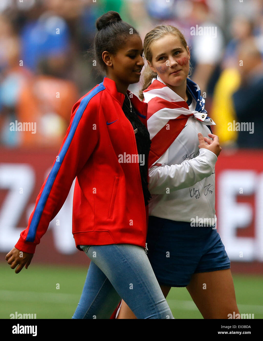 Vancouver, Canada. 05th July, 2015. Sasha Obama (L), daughter of U.S. President Barack Obama, and Maisy Biden, granddaughter of U.S. Vice President Joe Biden, walk off the pitch after talking with the U.S. team after the final of FIFA Women's World Cup 2015 between the United States and Japan at BC Place Stadium in Vancouver, Canada on July 5, 2015. The United States claimed the title after defeating Japan with 5-2. Credit:  Xinhua/Alamy Live News Stock Photo