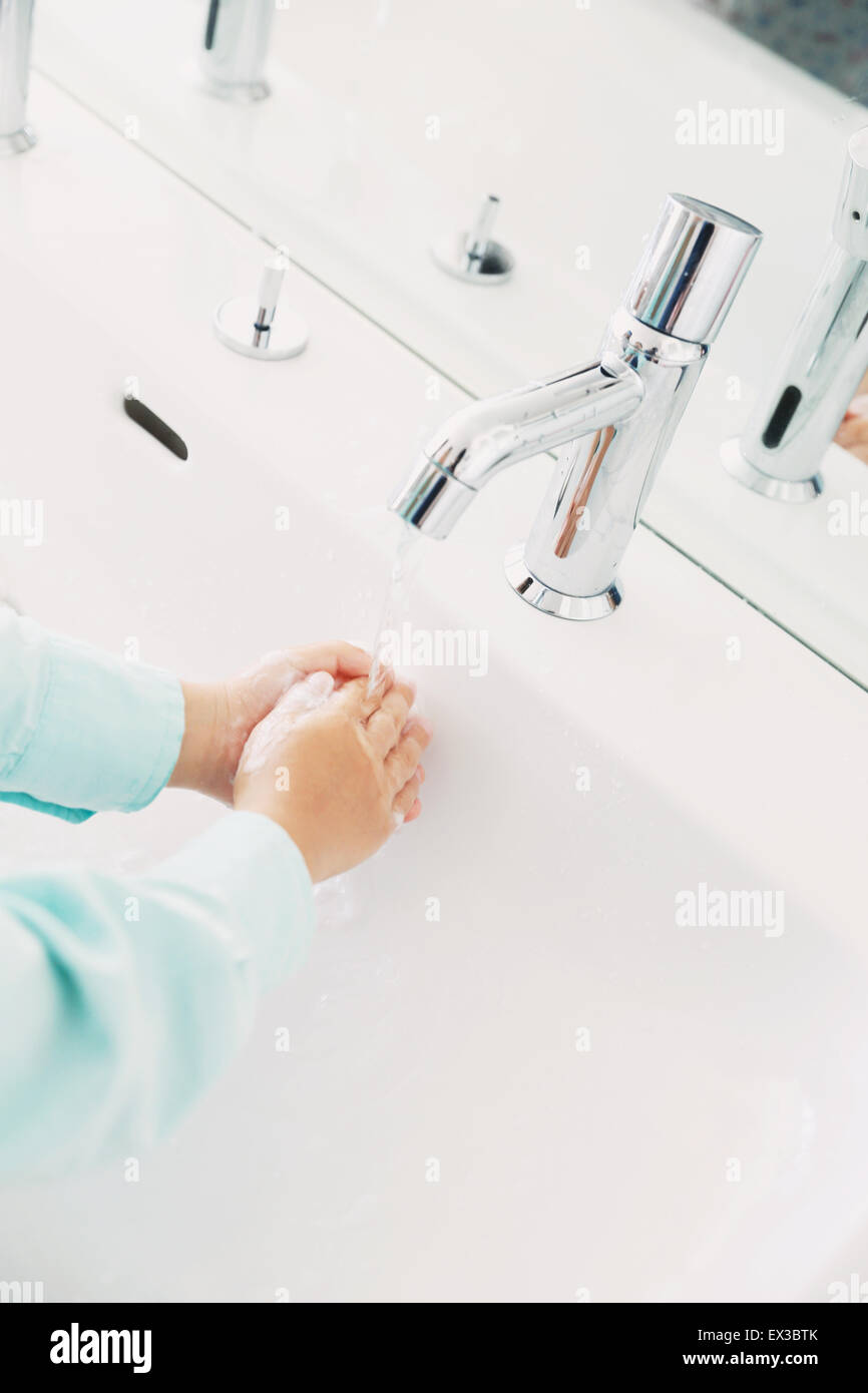 Japanese kid washing hands in the bathroom Stock Photo