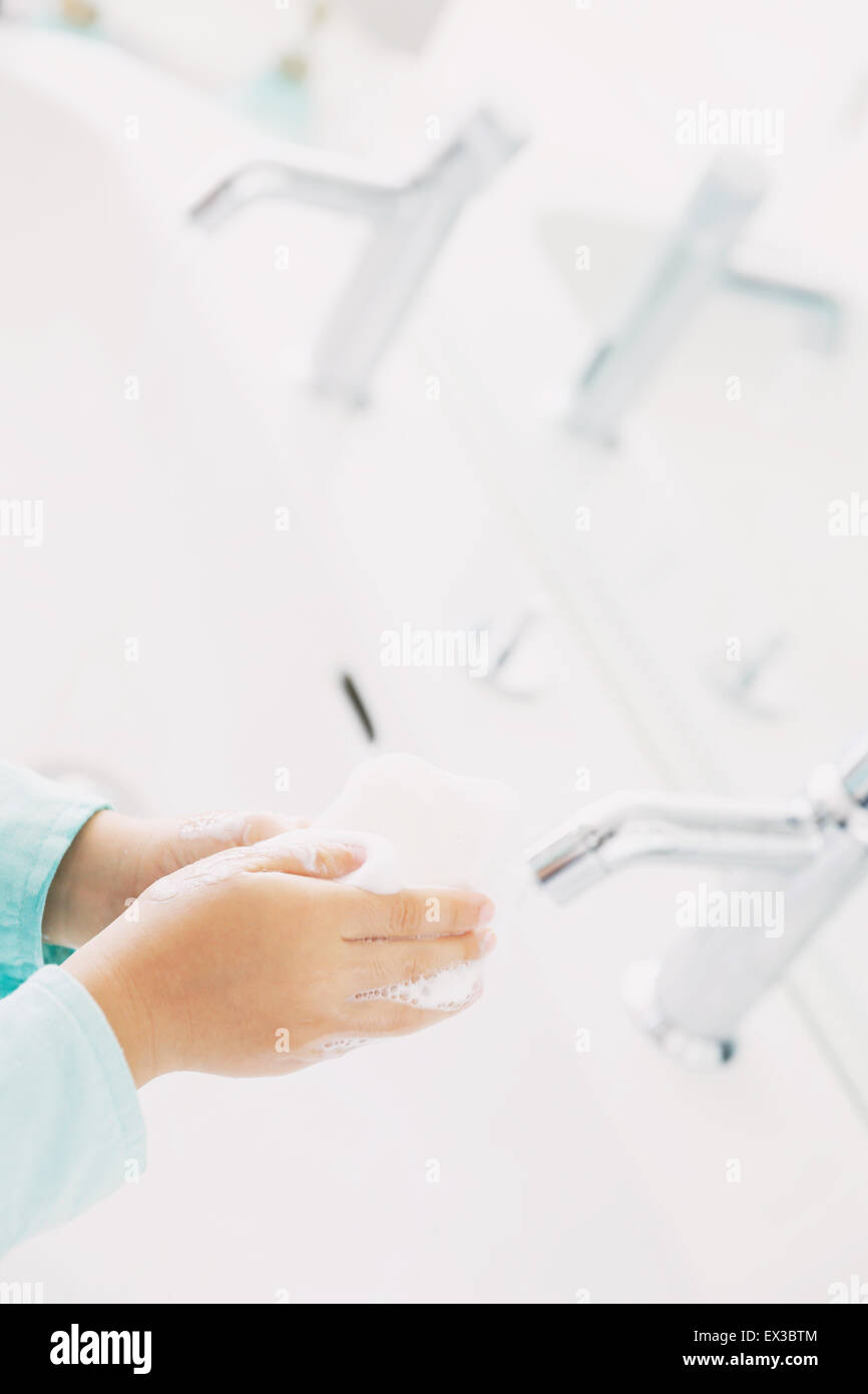 Japanese kid washing hands in the bathroom Stock Photo