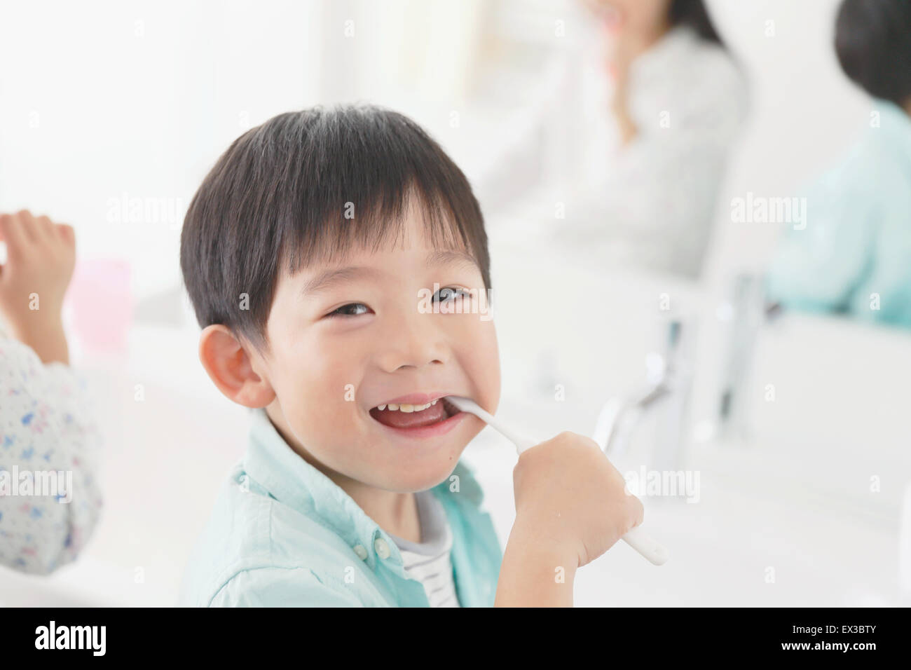 Japanese kid brushing teeth in the bathroom Stock Photo Alamy